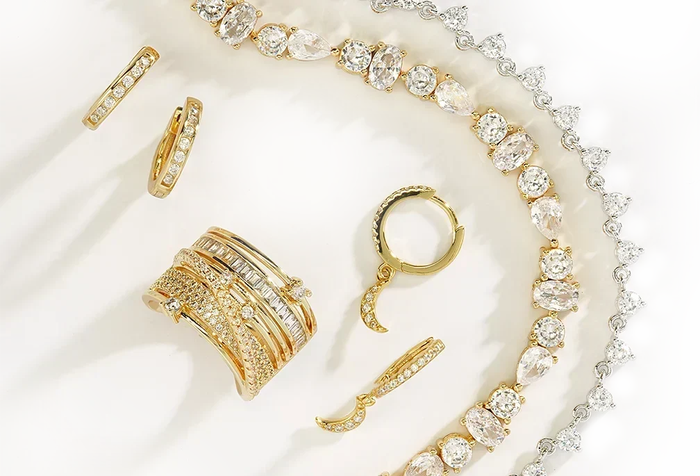 Sterling silver rings, earrings, necklace, and bracelet arranged on a white decorative plate.