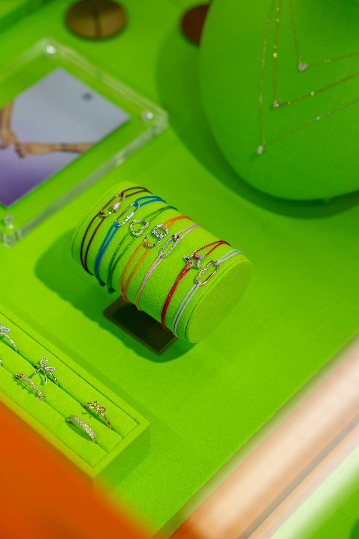Jewelry display with colorful bracelets and rings.