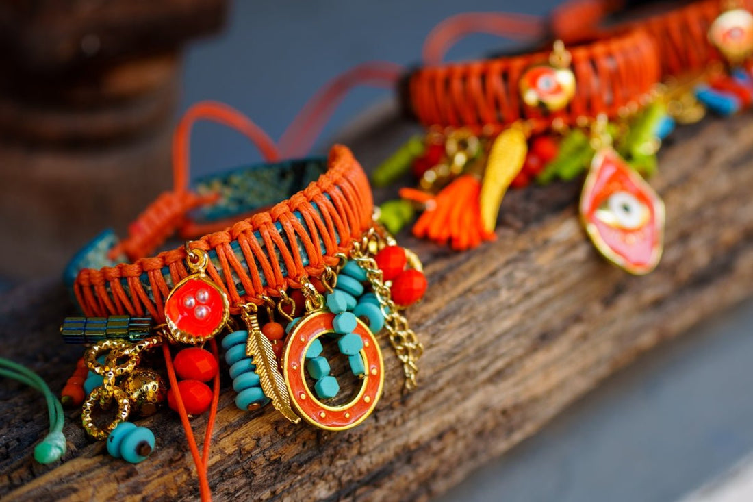 a bunch of bracelets that are sitting on a piece of wood