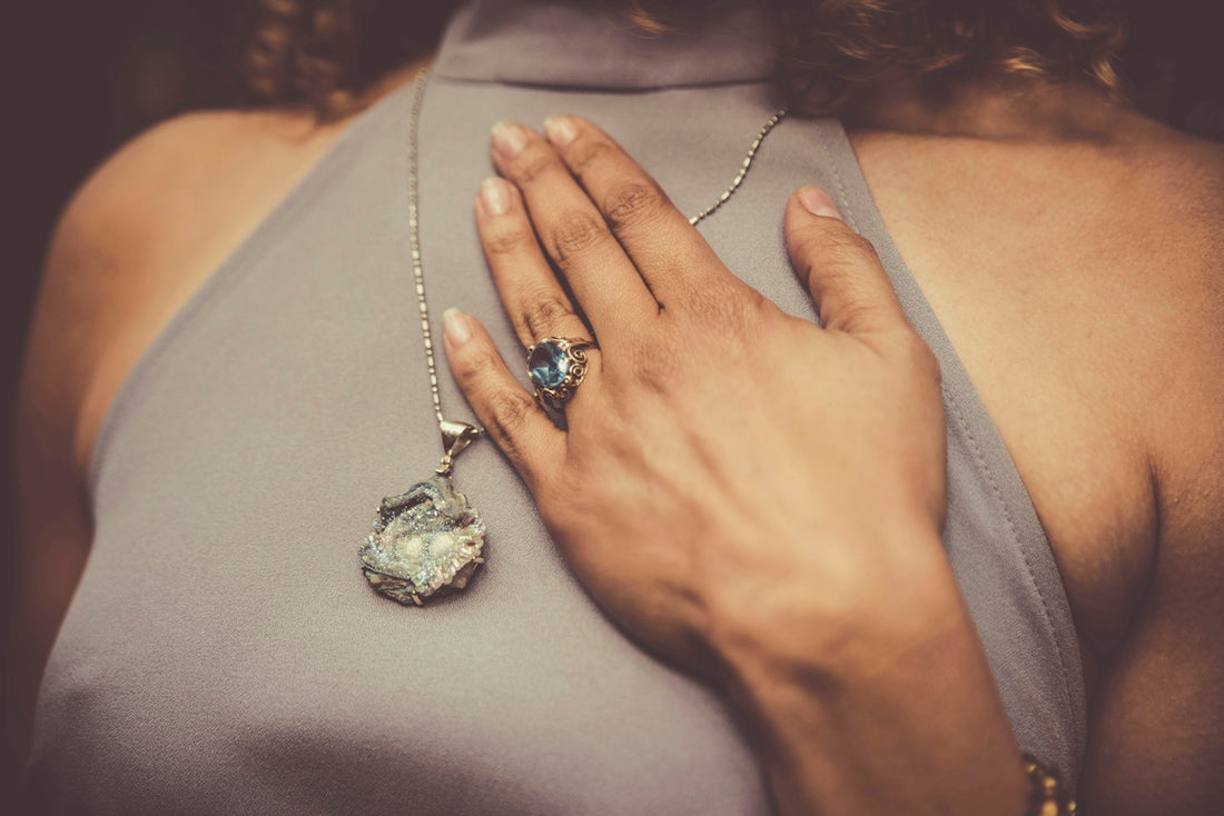 woman holding her chest close-up photo
