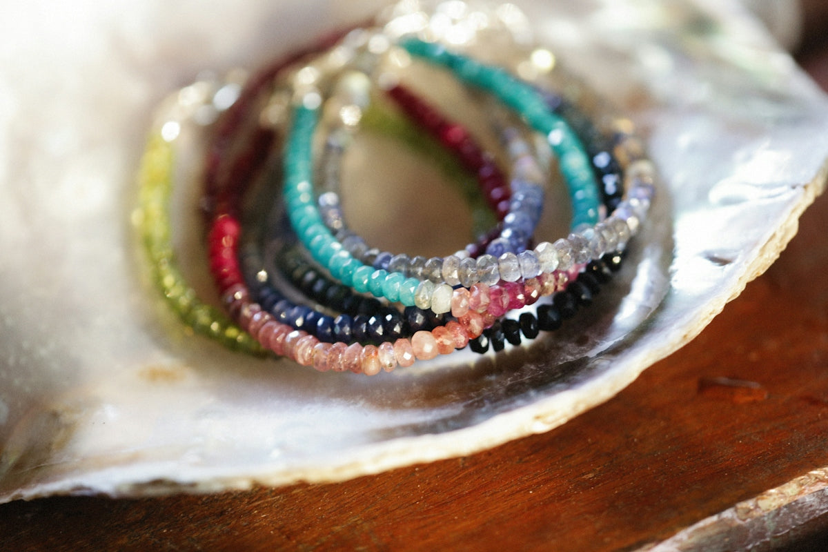 a group of bracelets sitting on top of a shell