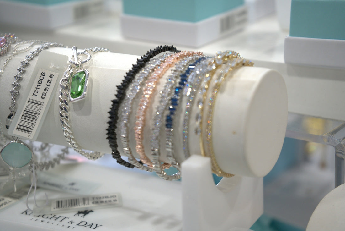 Bracelets are displayed on a white jewelry stand