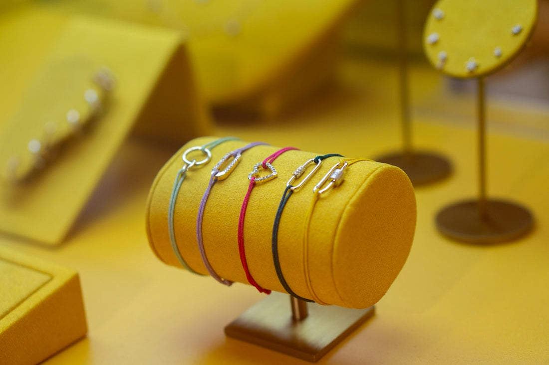 Colorful bracelets displayed on a yellow stand