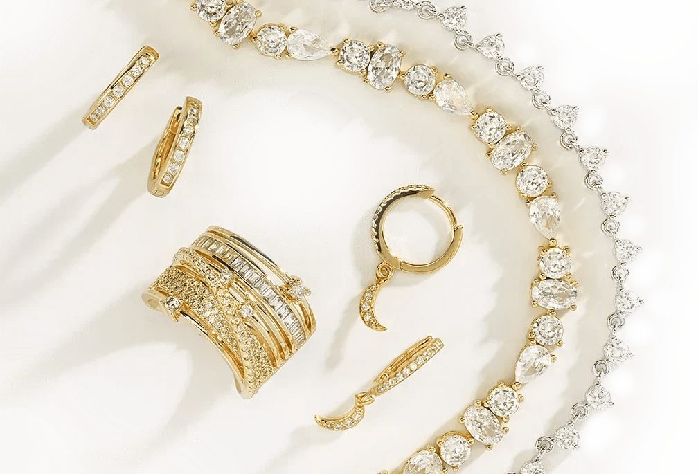 Sterling silver rings, earrings, necklace, and bracelet arranged on a white decorative plate.