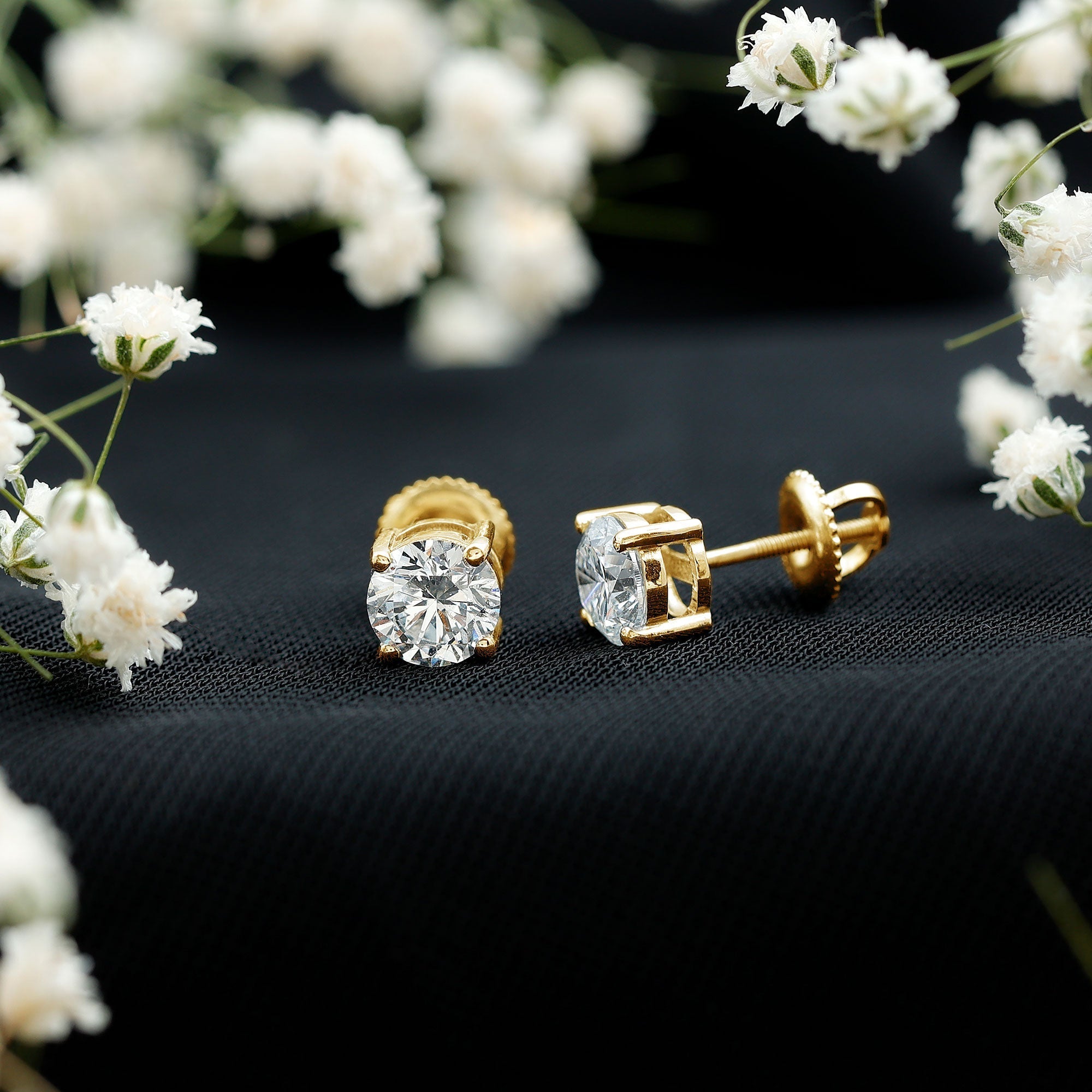 Women's earrings featuring gold hoops, delicate studs, statement designs and elegant fine jewelry styles