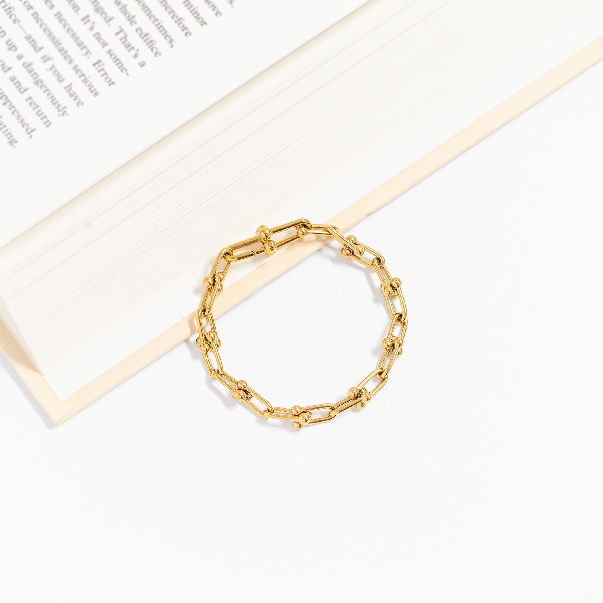 Waterproof gold and stainless steel bracelets including charm, chain, and engravable styles
