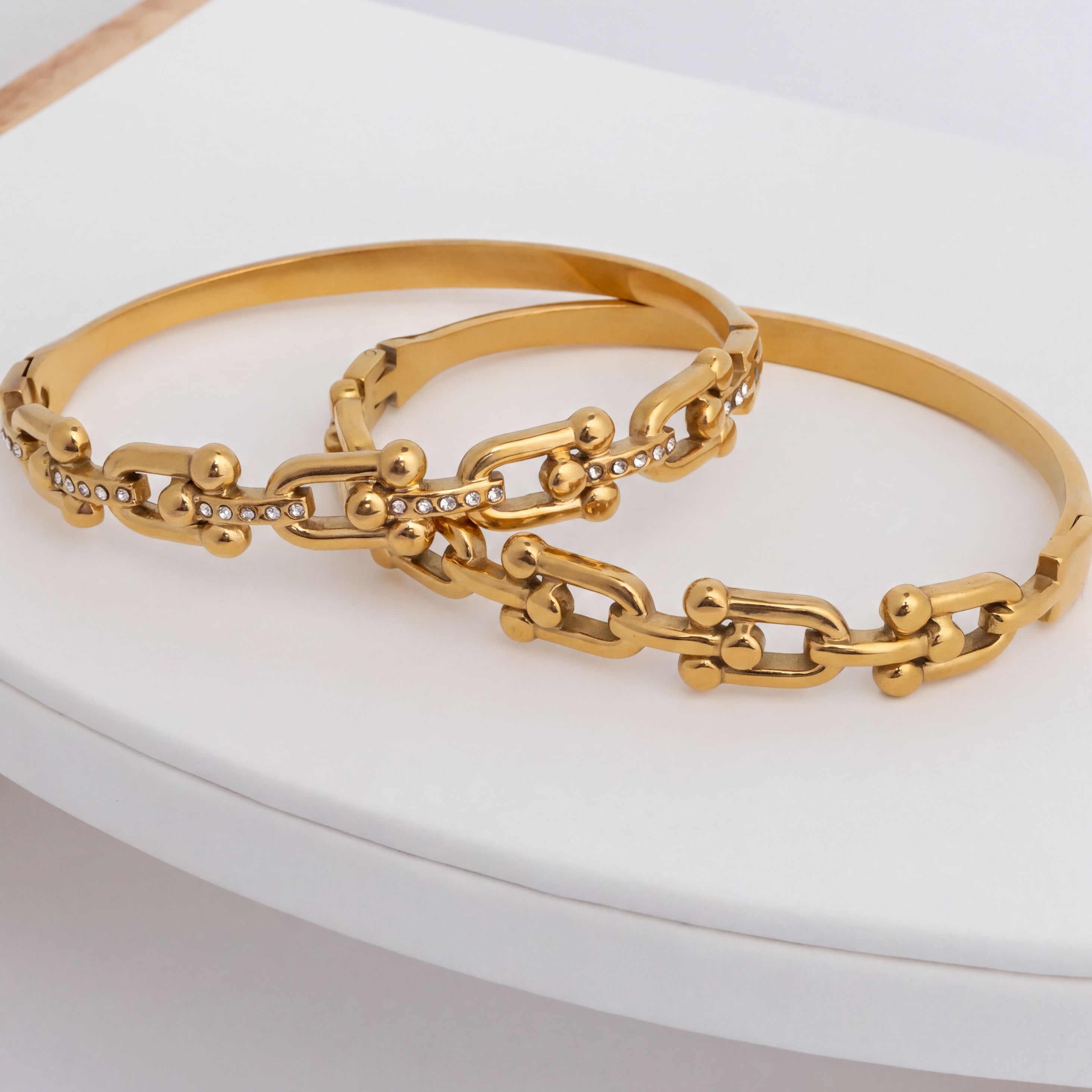 Gold chain bracelet on a white surface