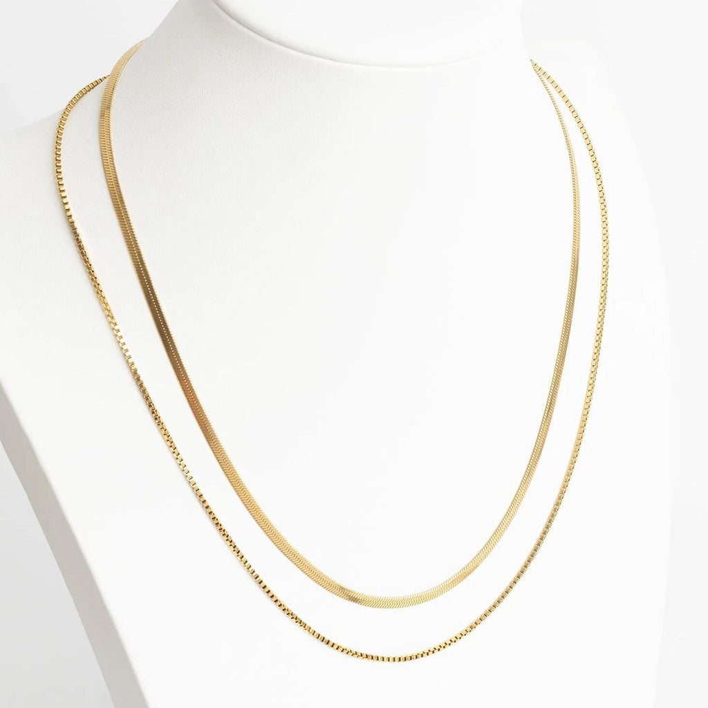 Gold chain necklace on a mannequin with a white background
