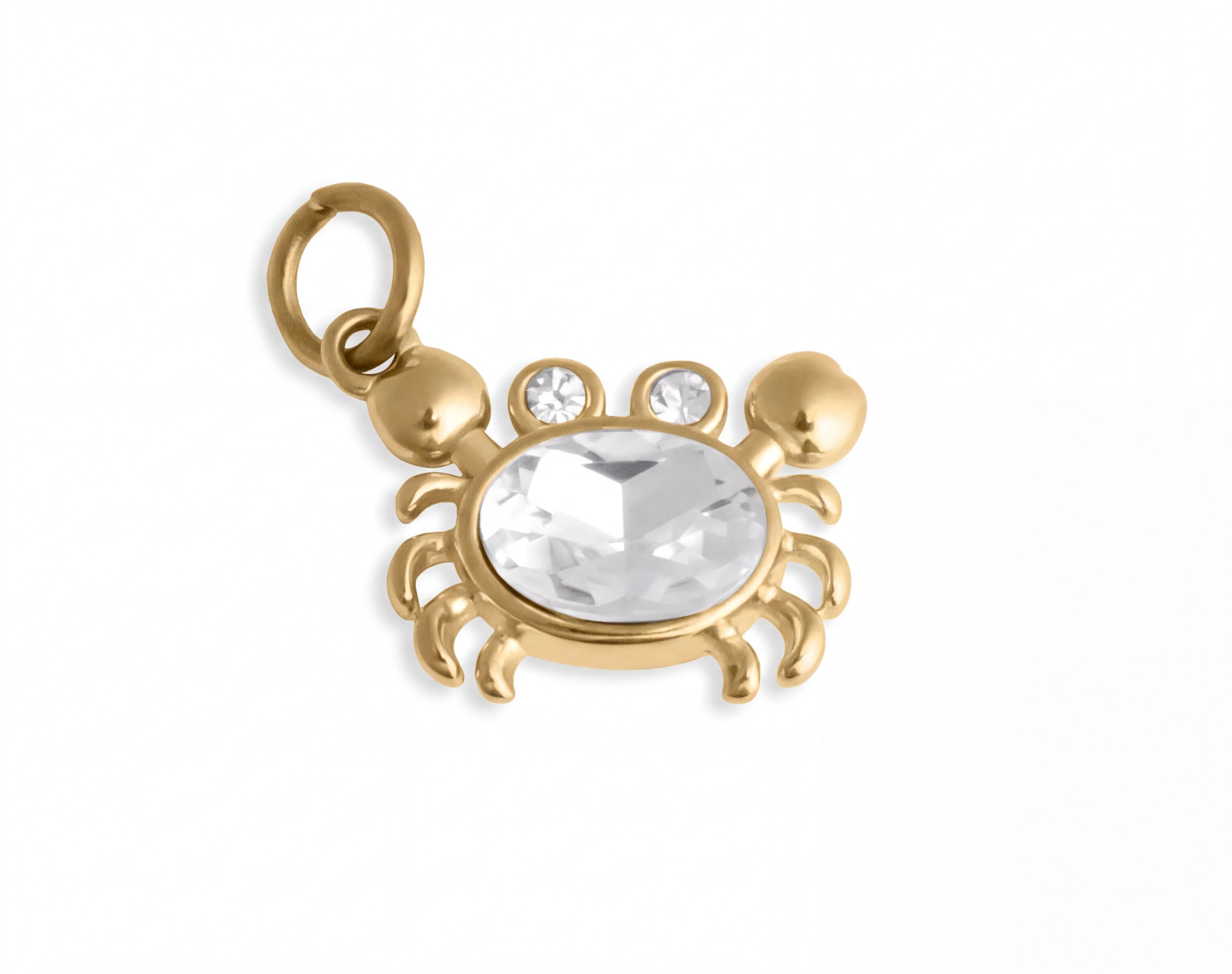 A gold-colored charm in the shape of a crab with a clear gemstone in the center.