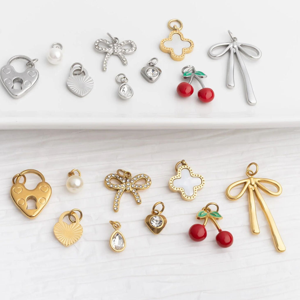 Collection of various jewelry charms on a white background