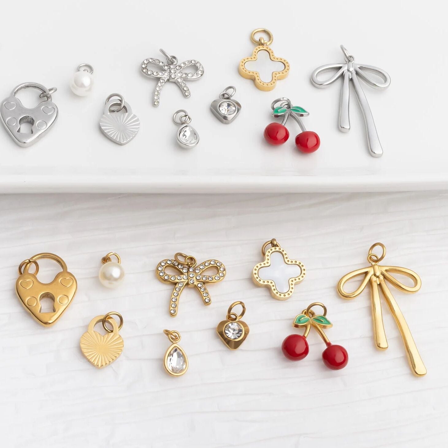 Collection of various jewelry charms on a white background