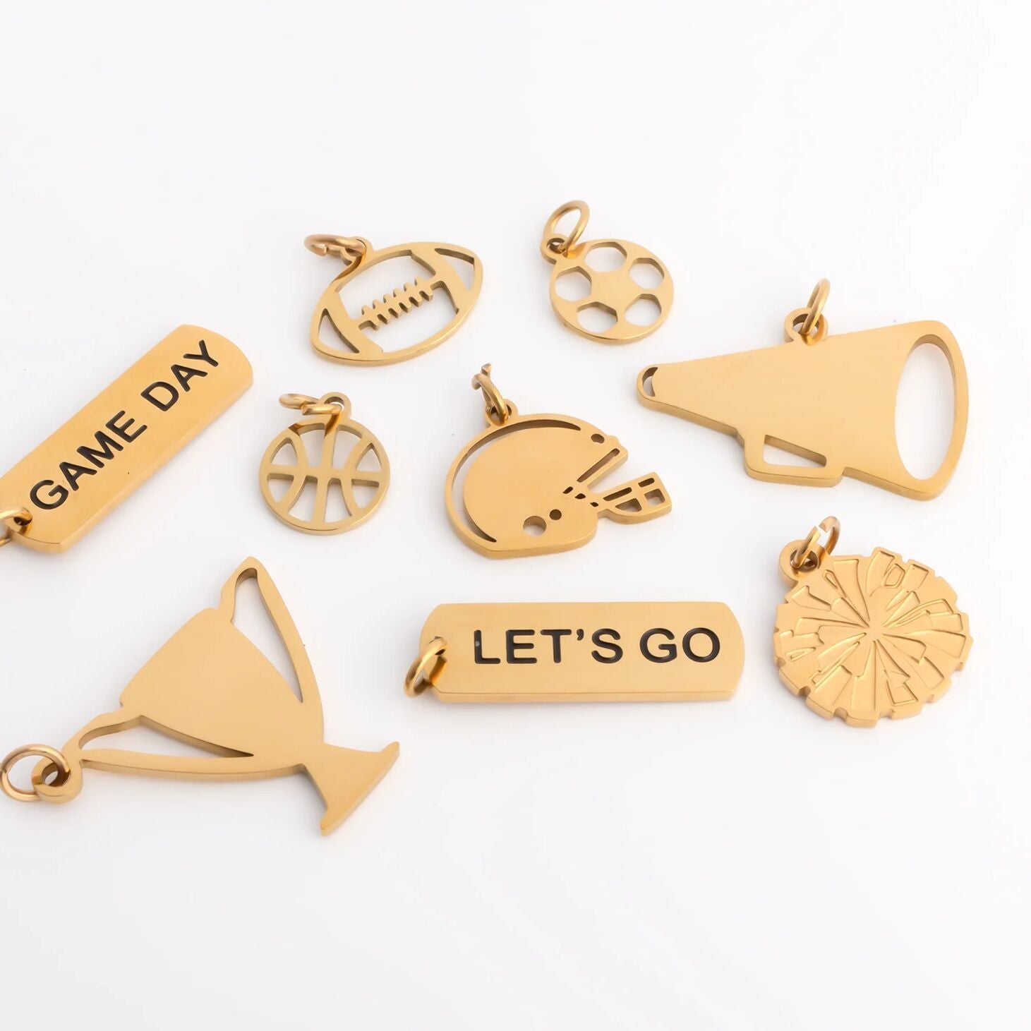 Collection of gold-themed pendants on a white background