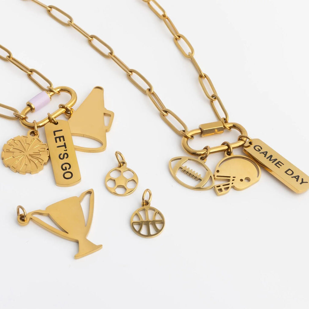 Gold necklaces with various charms on a white background