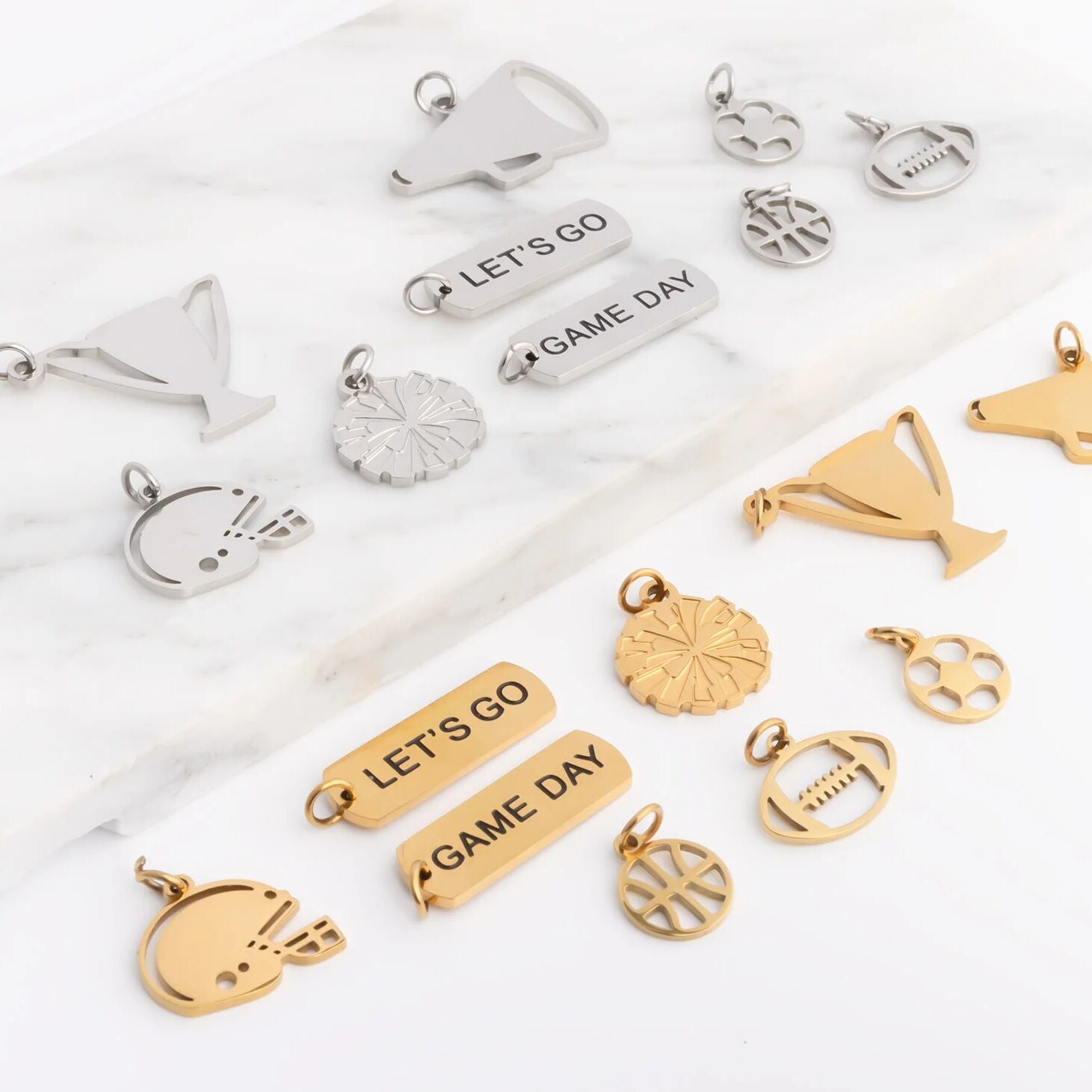 Collection of various gold and silver charms on a white background