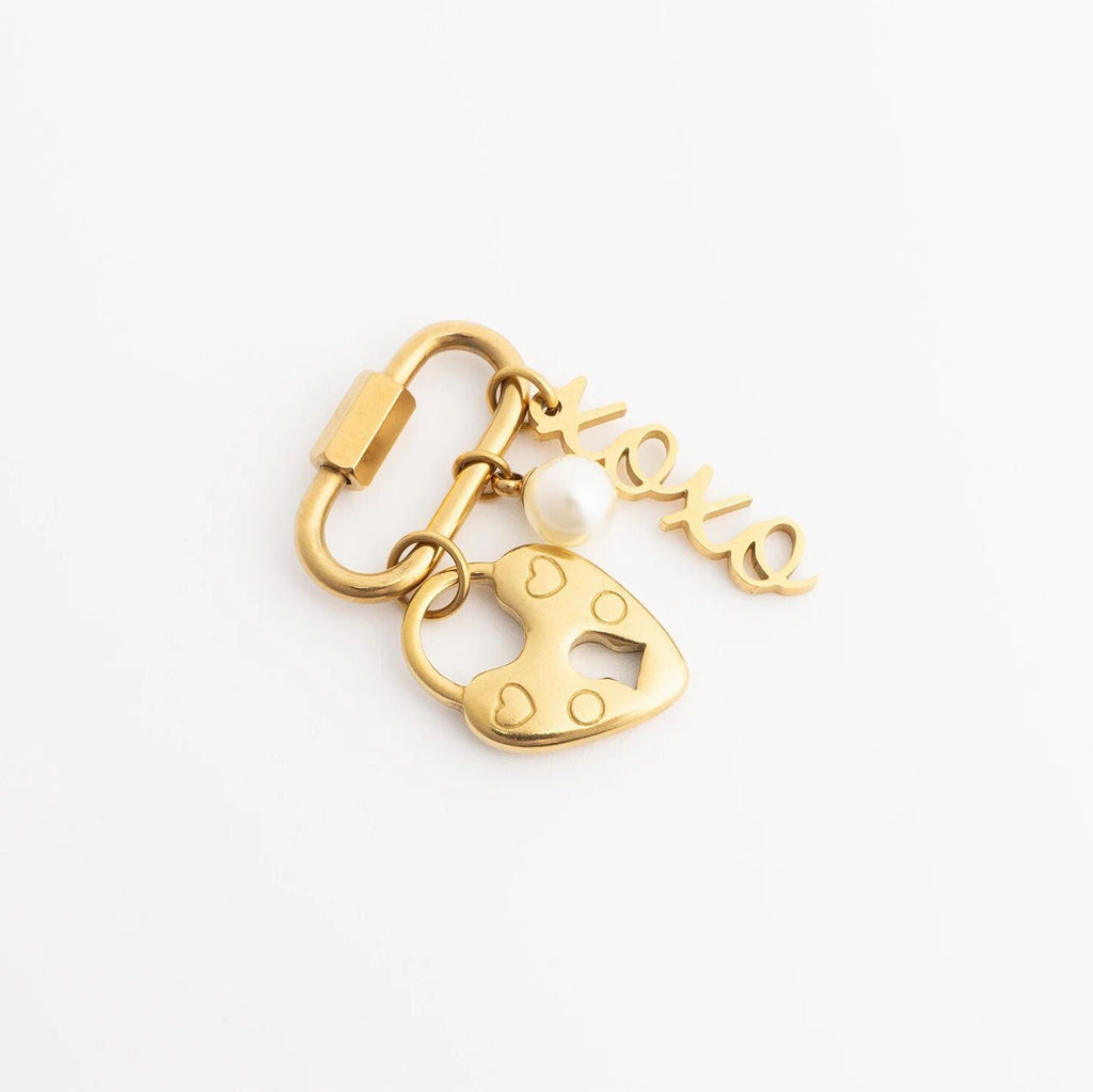Gold keychain with heart-shaped padlock and 'love' tag on a white background