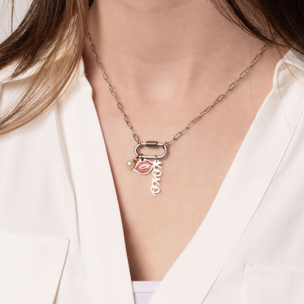 Necklace with pendant on a person wearing a white outfit