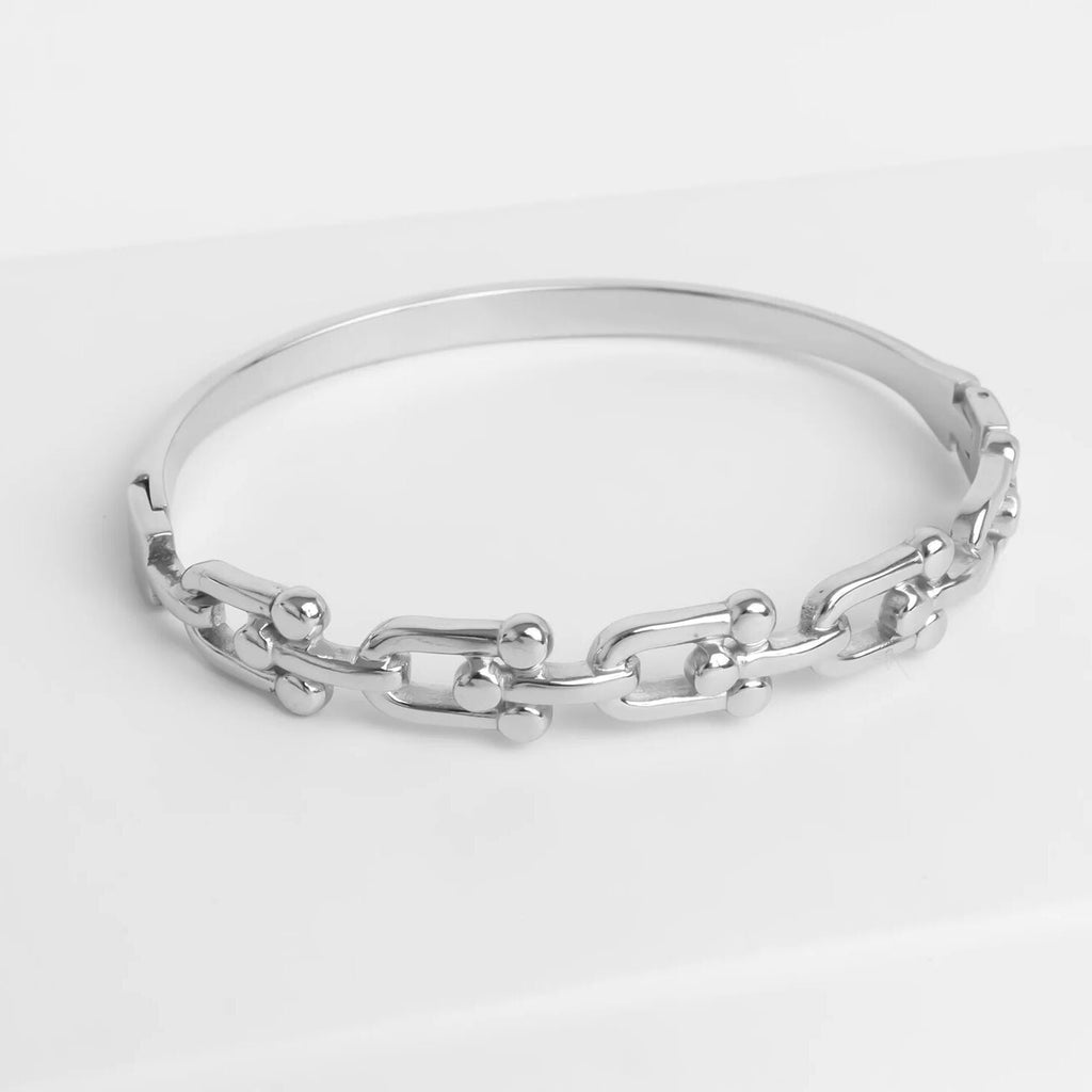Silver chain bracelet on a light gray background