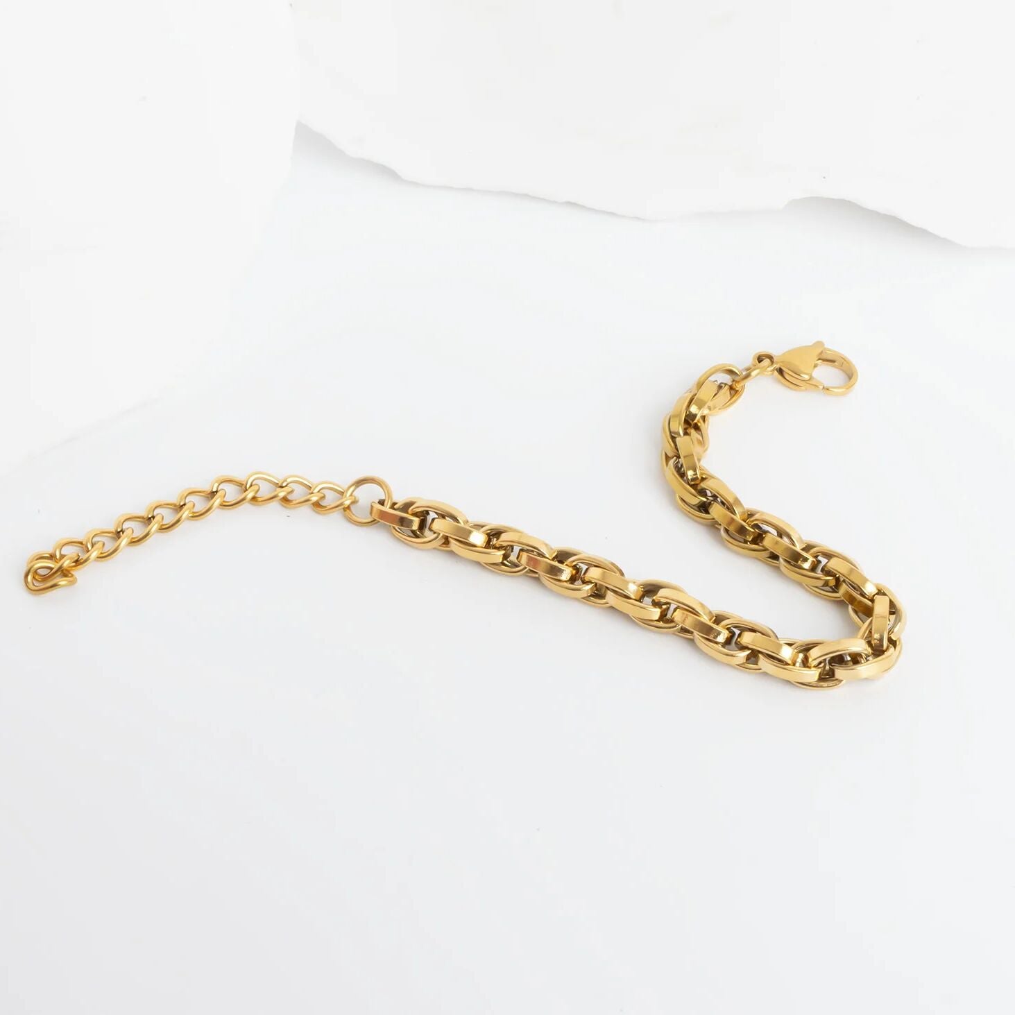 Gold chain bracelet on a white background