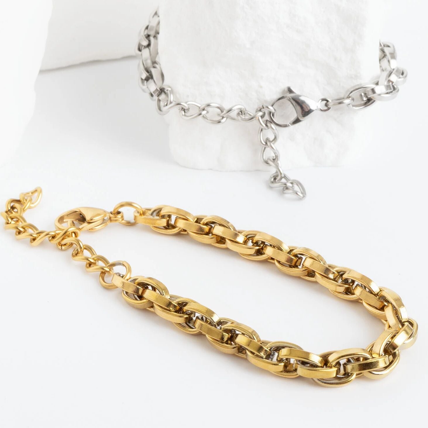 Gold and silver chain necklaces on a white background