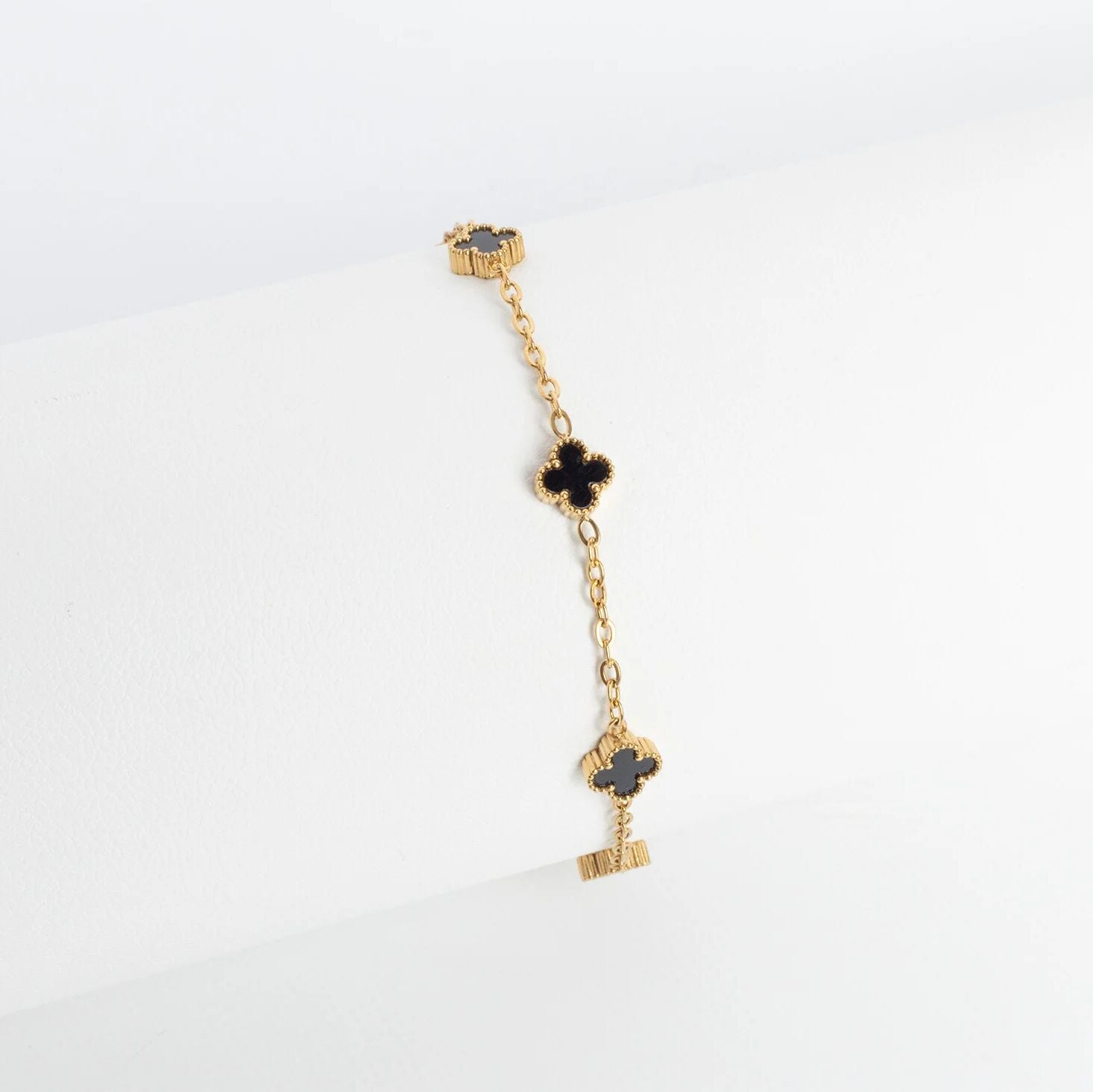 Gold Small Floral Motif Bracelet  with black heart charms on a white background