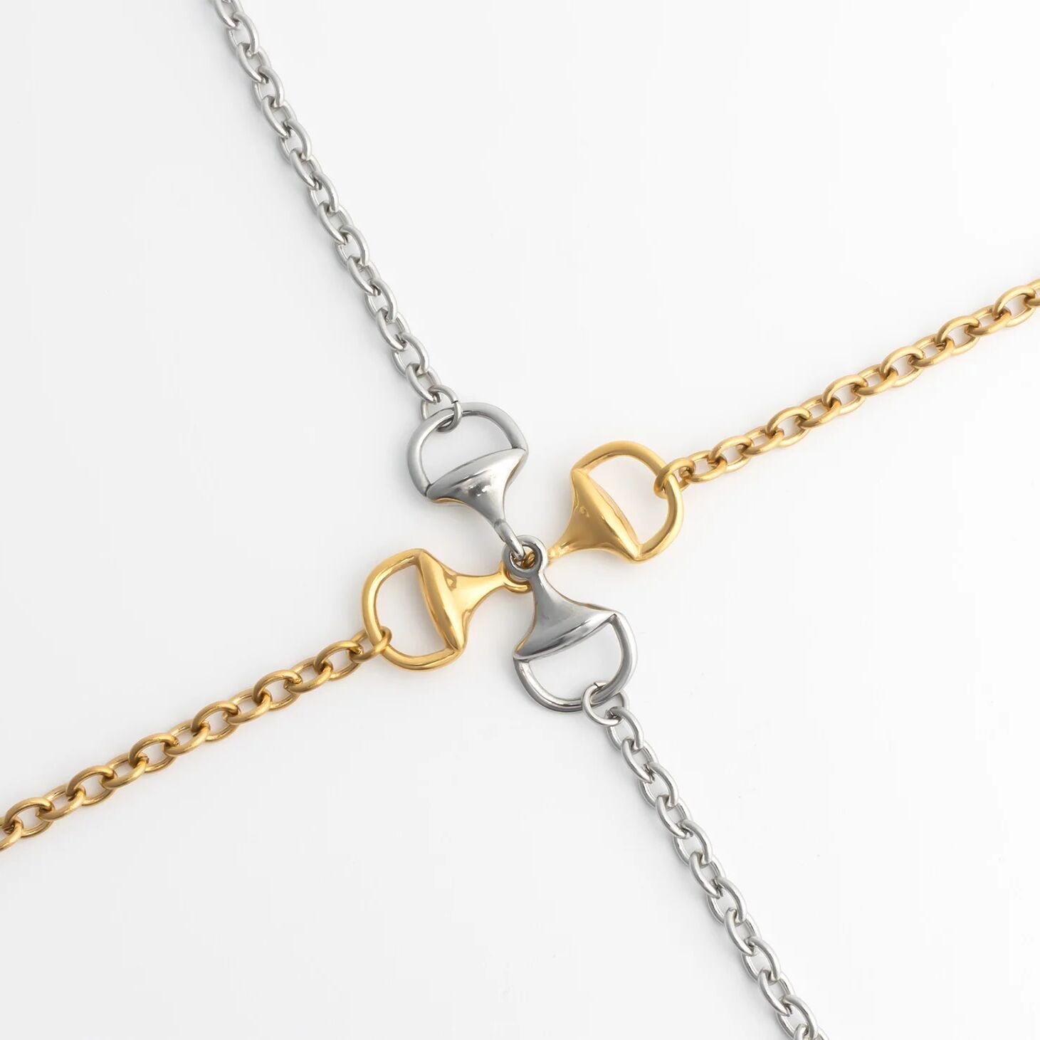 Two gold and silver chain Horsebit Bracelets on a white background