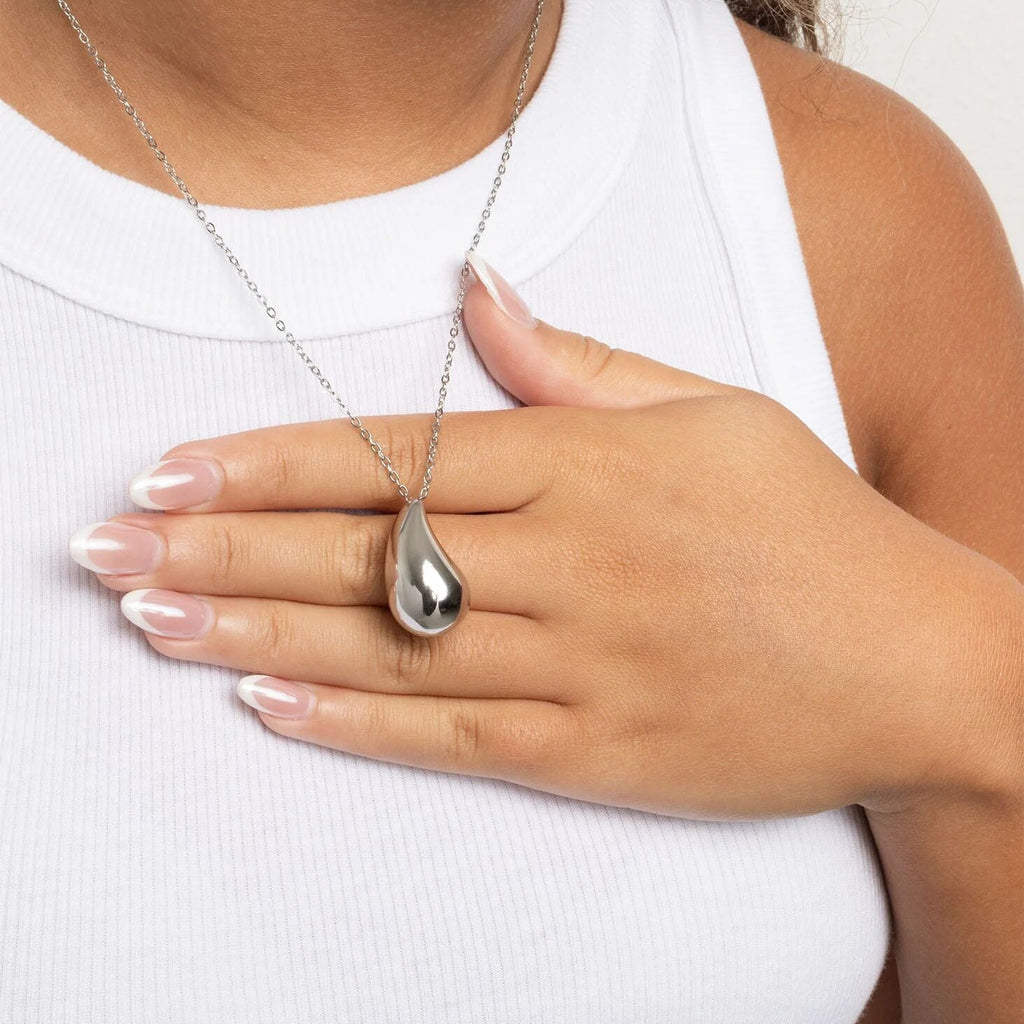 Silver teardrop pendant necklace on a white background