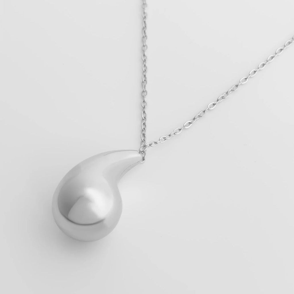 Silver Tear Drop Charm Necklace against a light gray background