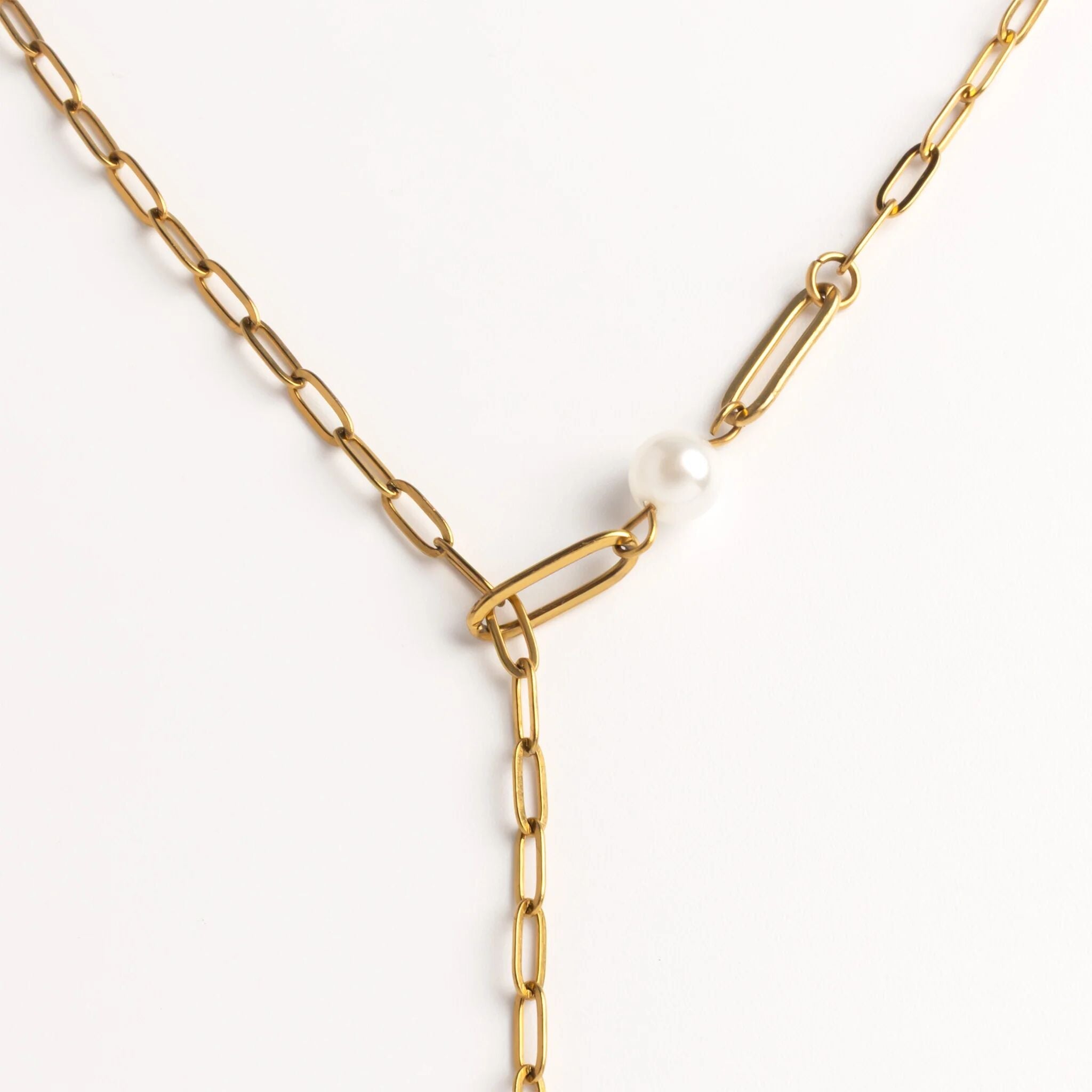 Gold chain necklace with a pearl pendant on a white background