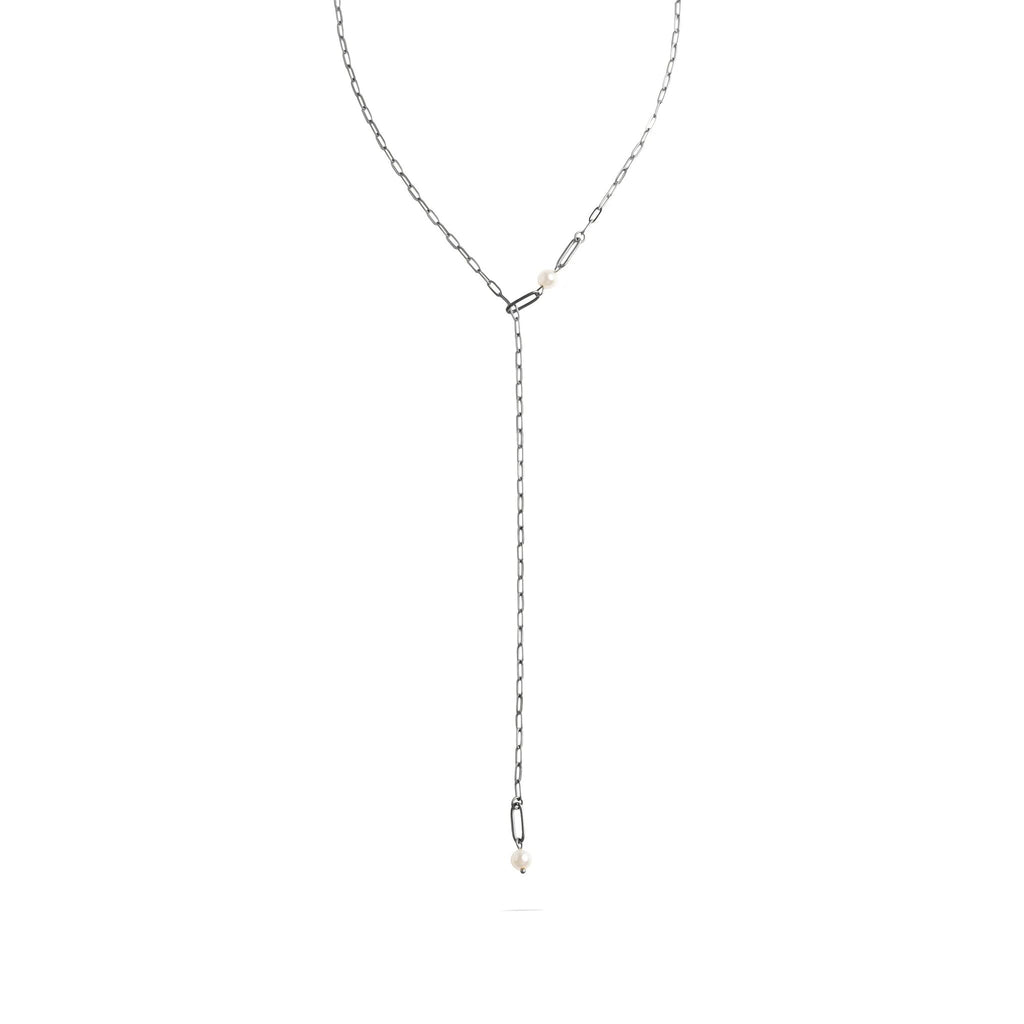 Silver lariat necklace on a white background