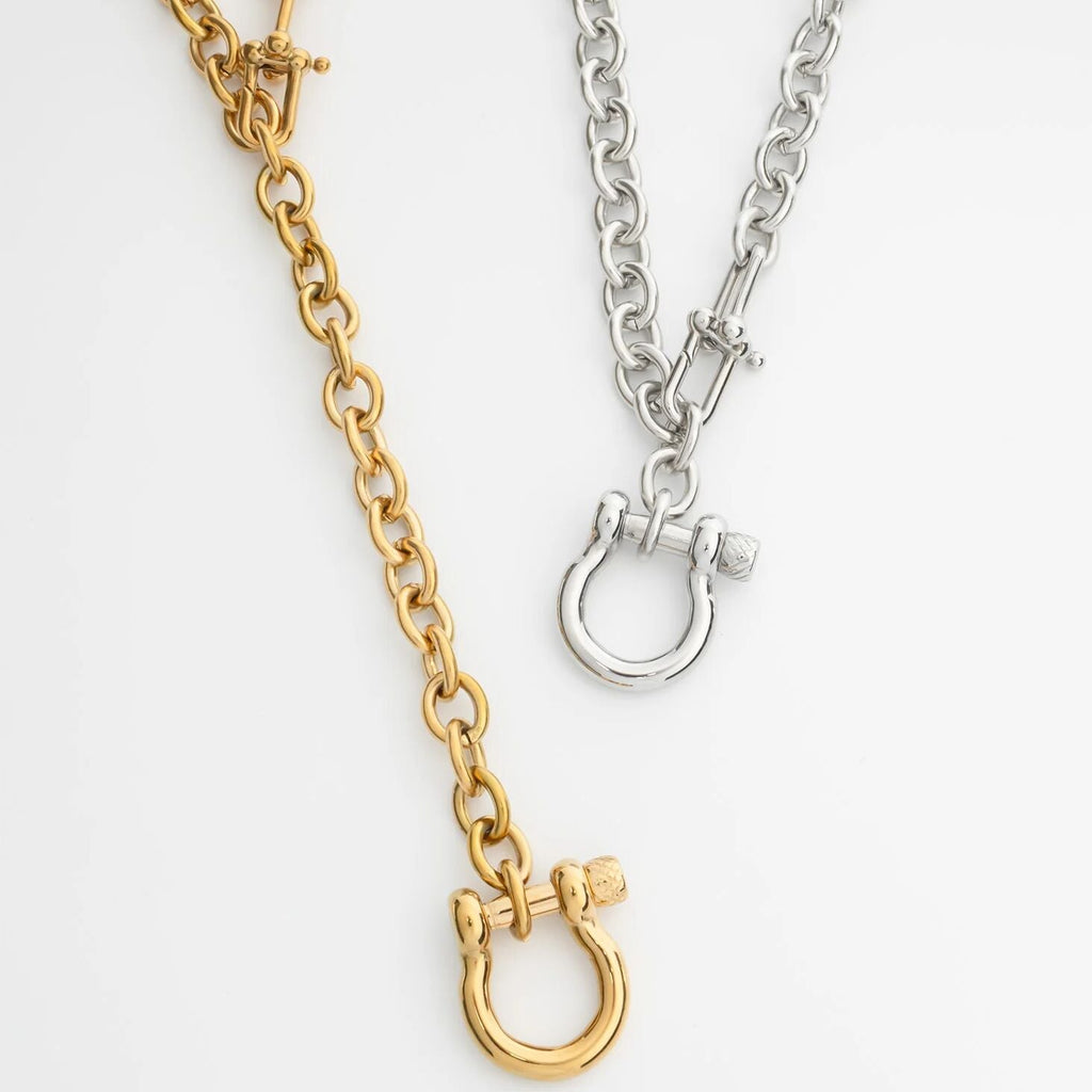 Gold and silver chain Y Necklace with Horse shoe Carabiners with clasp on a white background