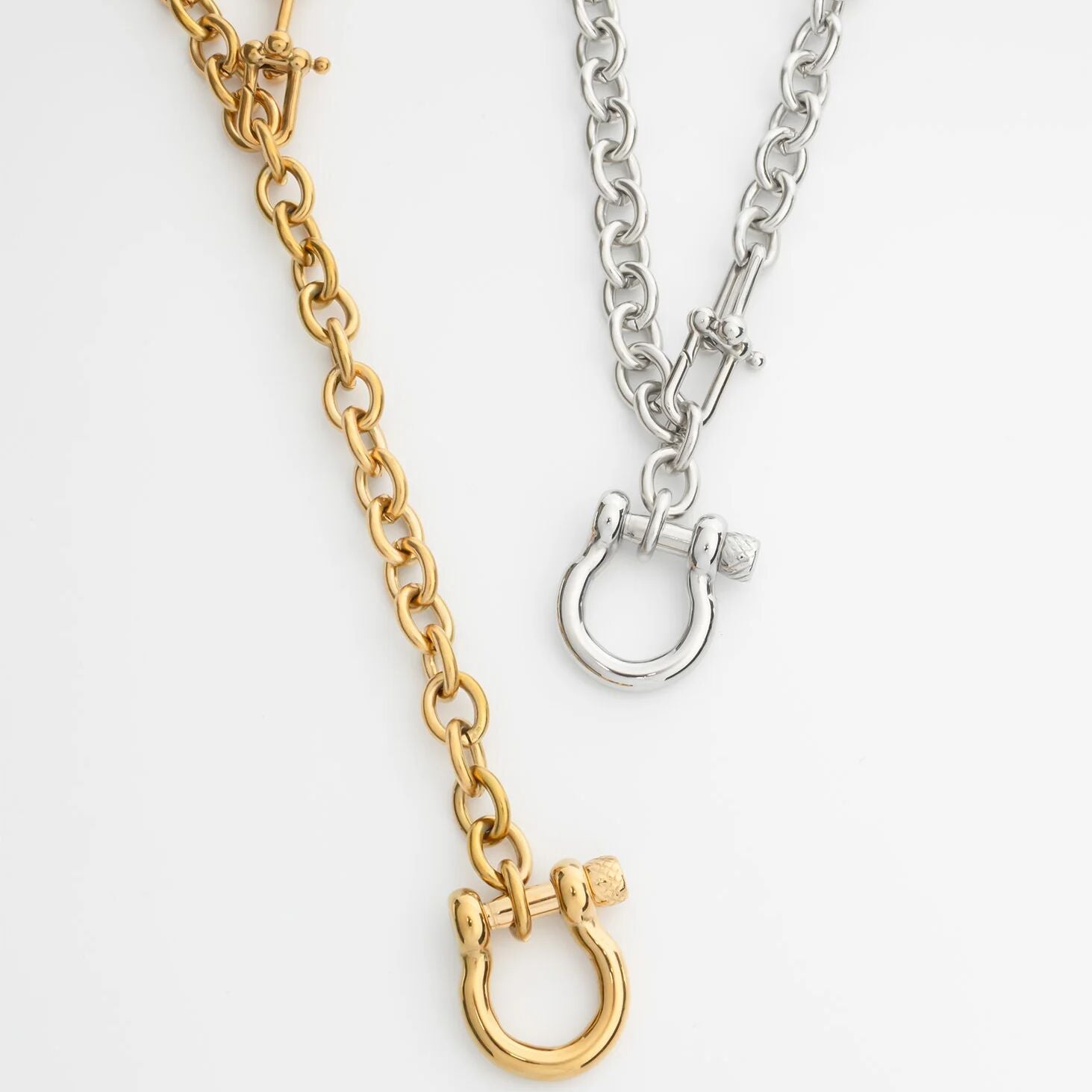 Gold and silver chain Y Necklace with Horse shoe Carabiners with clasp on a white background