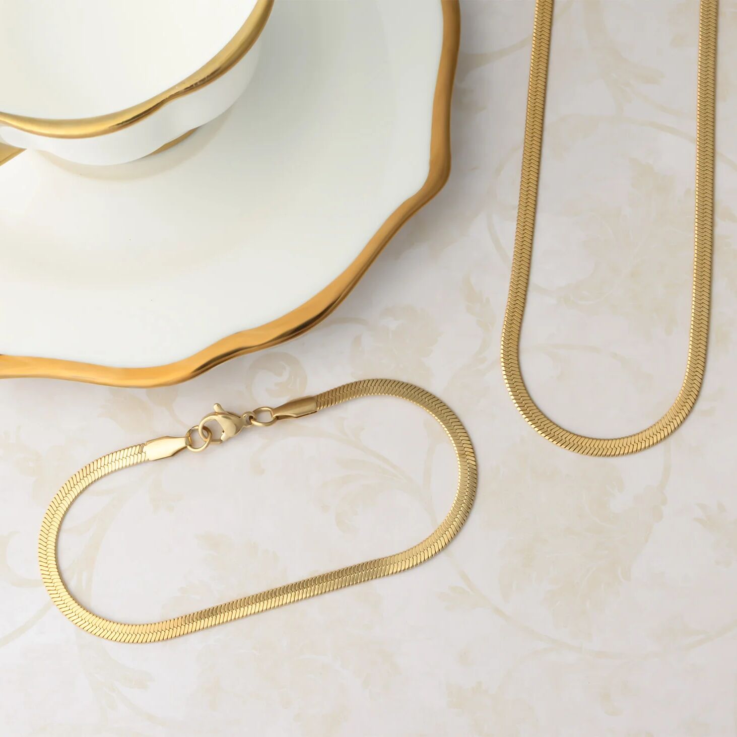 Gold chain necklace on a marble surface