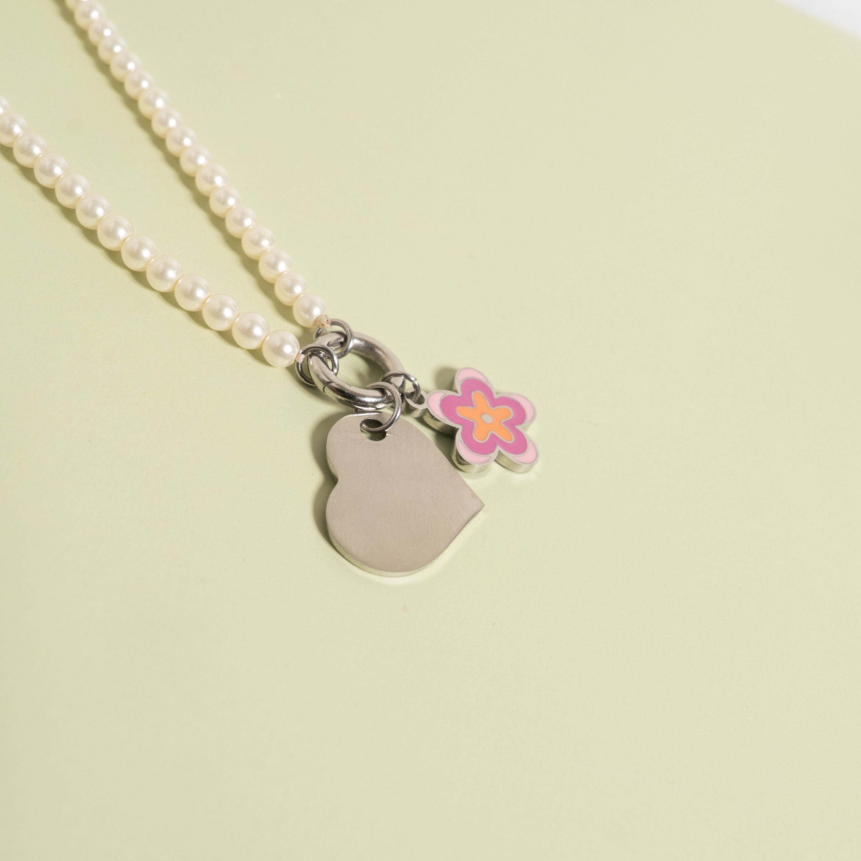Polished Heart Pendant with flower charm on pearl necklace