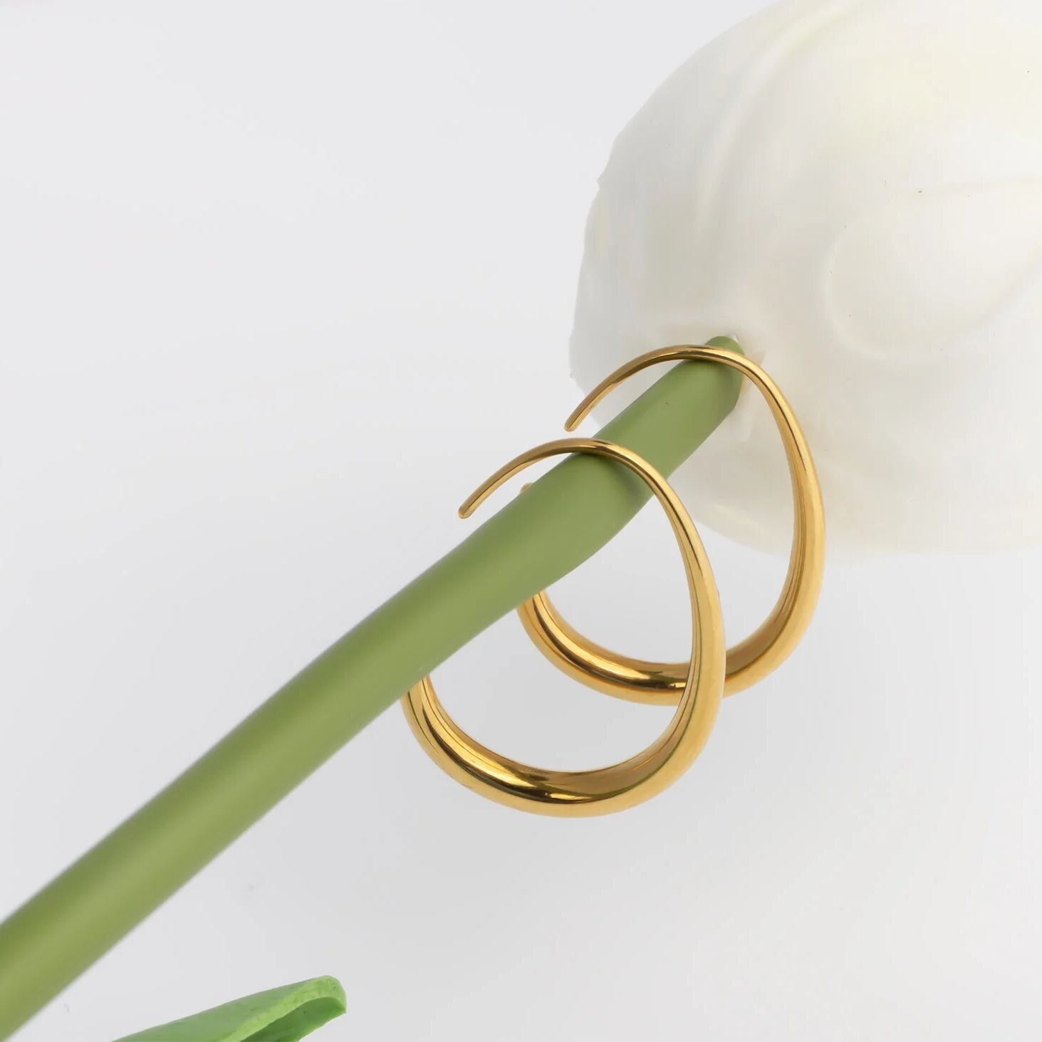 Gold hoop earrings on a white background