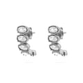 Pair of silver Oval Stone Huggie Earrings with clear gemstones on a white background