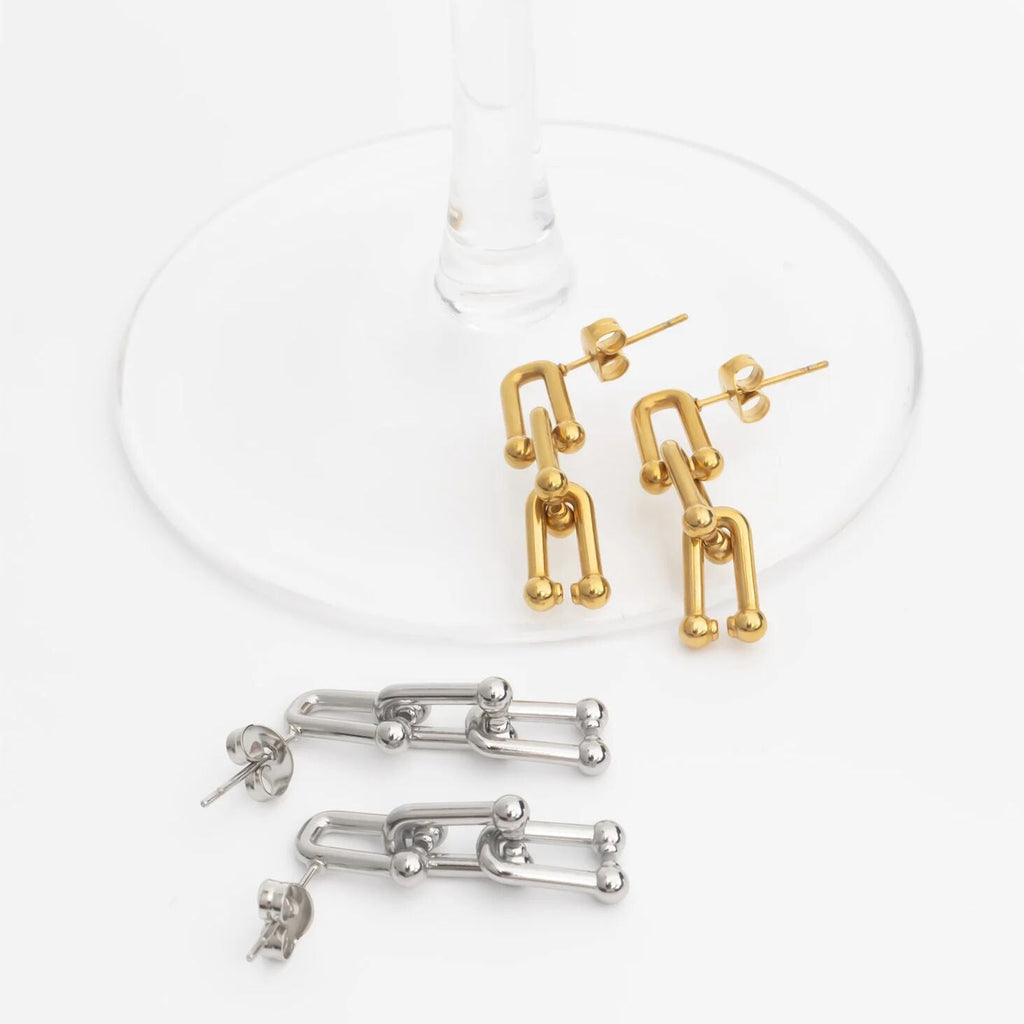 Gold and silver abstract earring set on a white background
