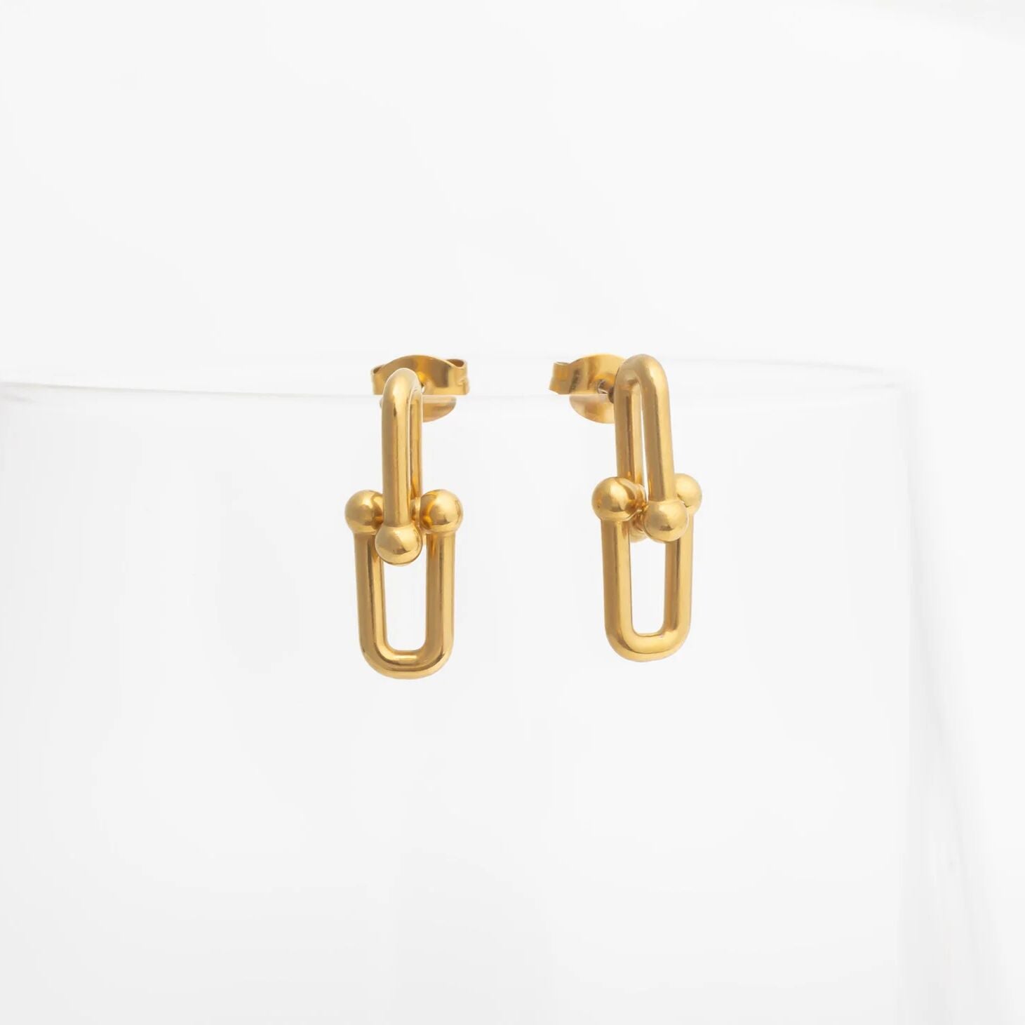 Gold hoop earrings on a white background
