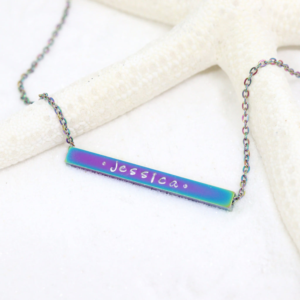 Life style photo with custom engraved chain necklace with bar pendant, the name "Jessica" inscribed on the pendant