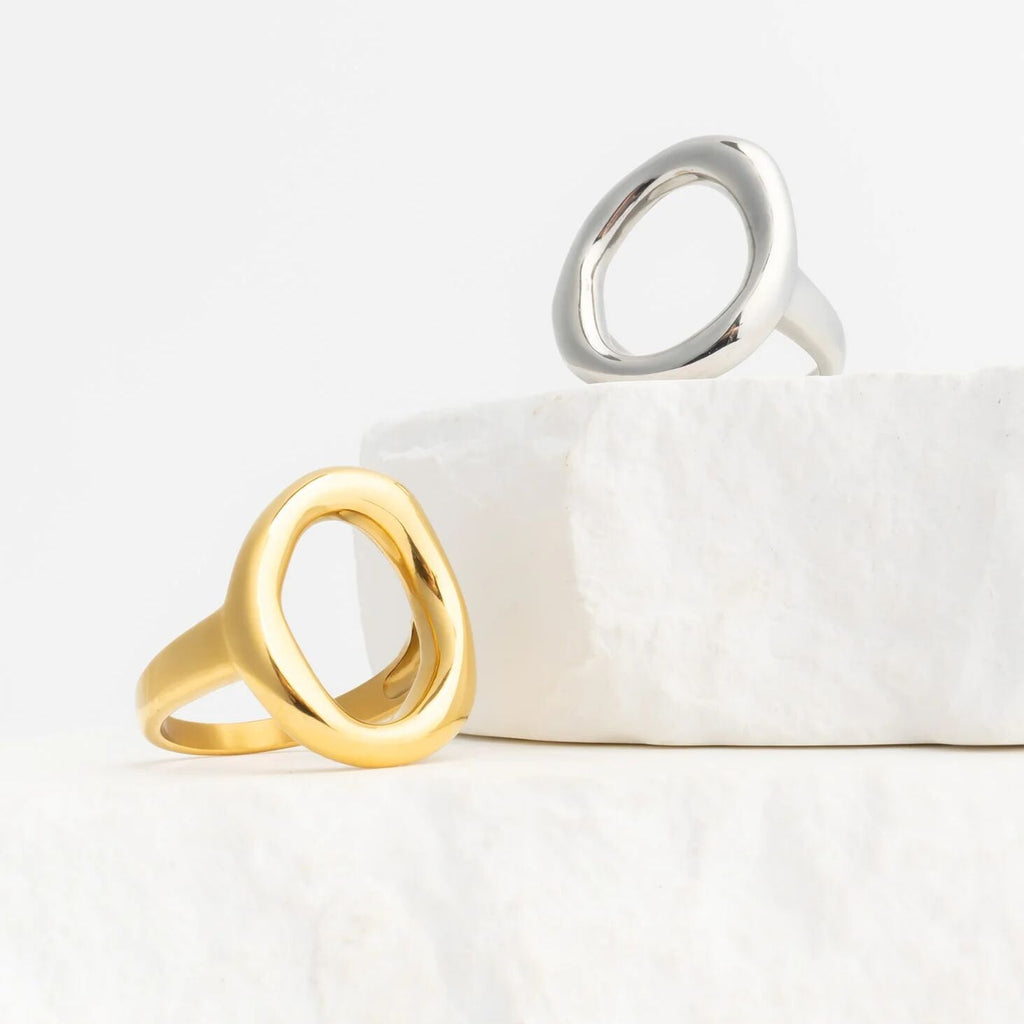 Gold and silver Oval Motif Rings on a white surface