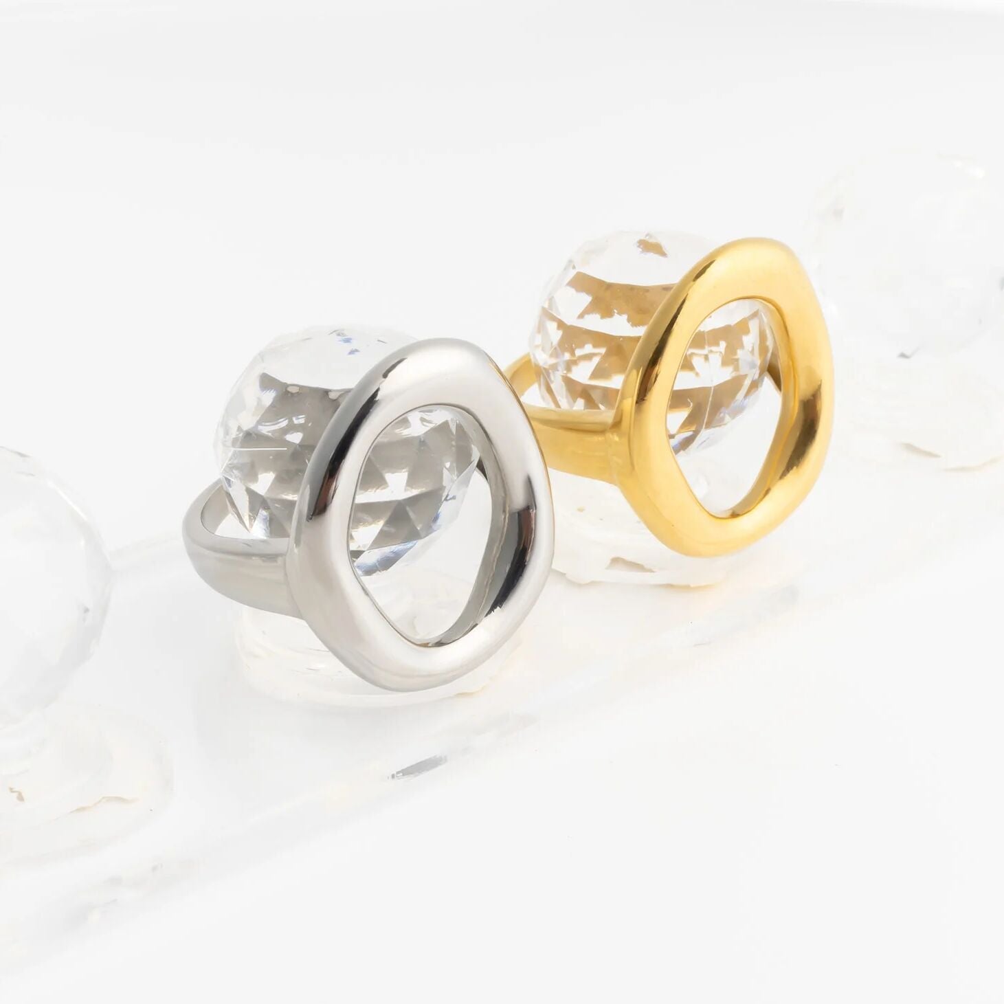 Gold and silver Oval Motif Rings on a white surface