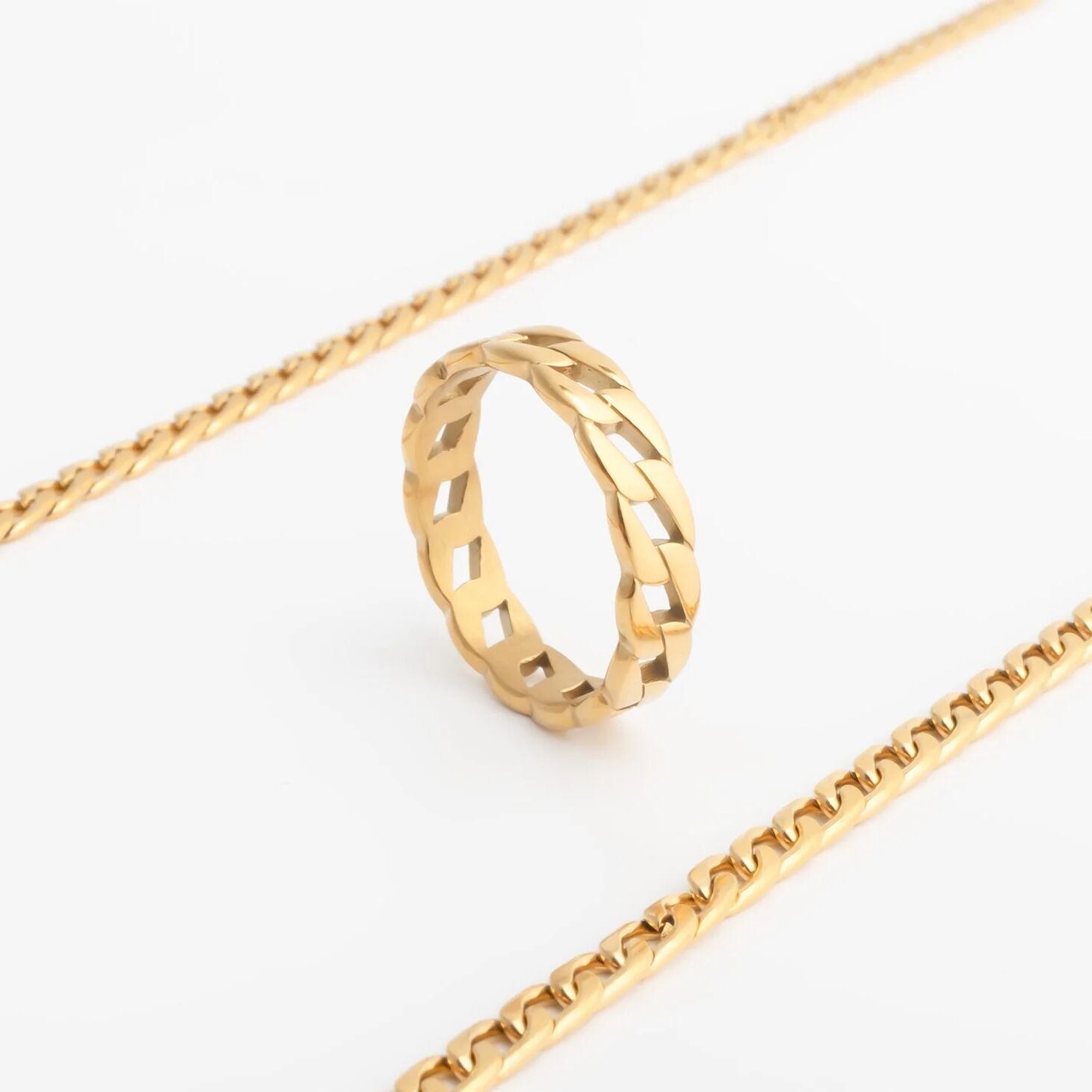 Gold Curb Chain Stacking Ring and gold chain on a white background