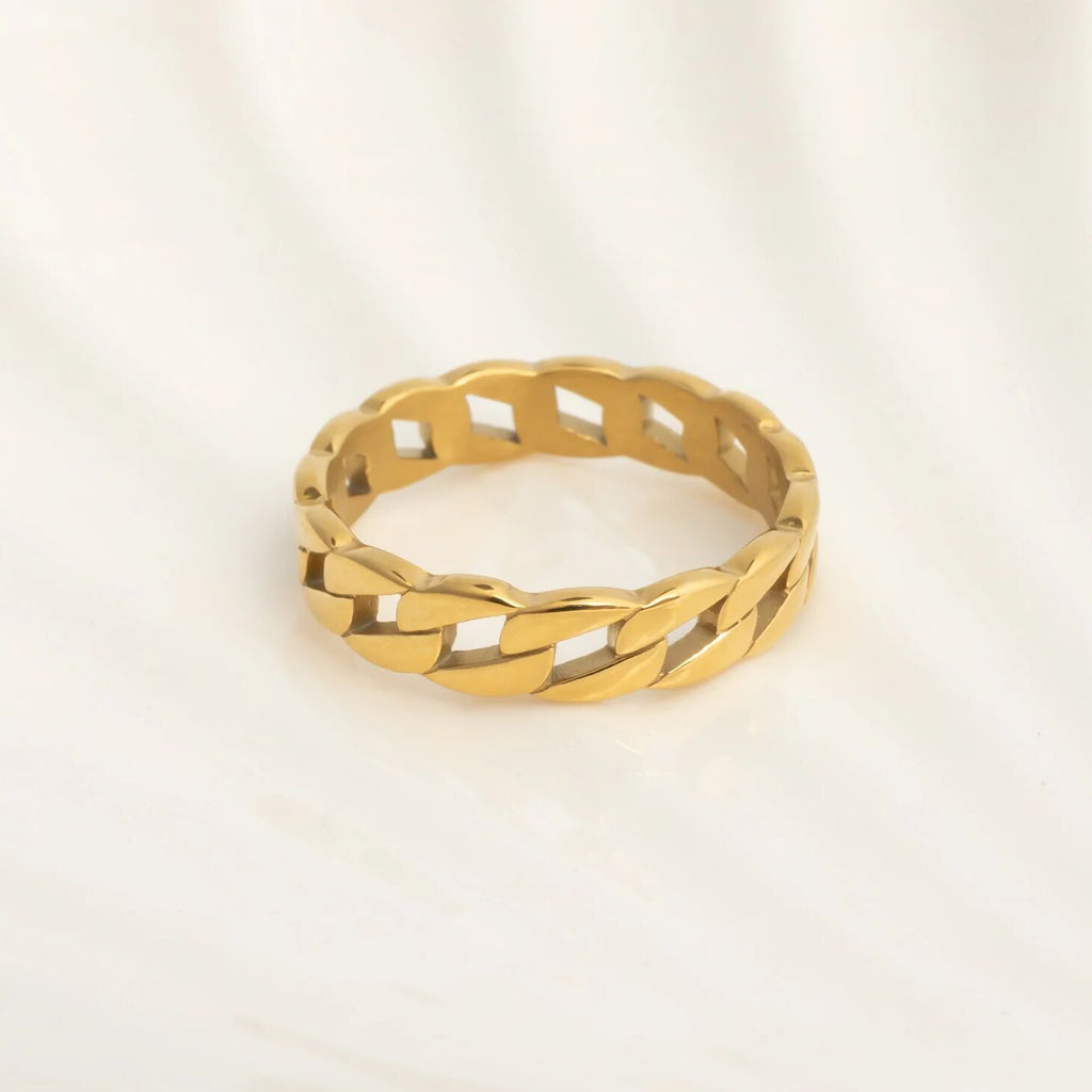 Gold Curb Chain Stacking Ring with braided design on a light beige background