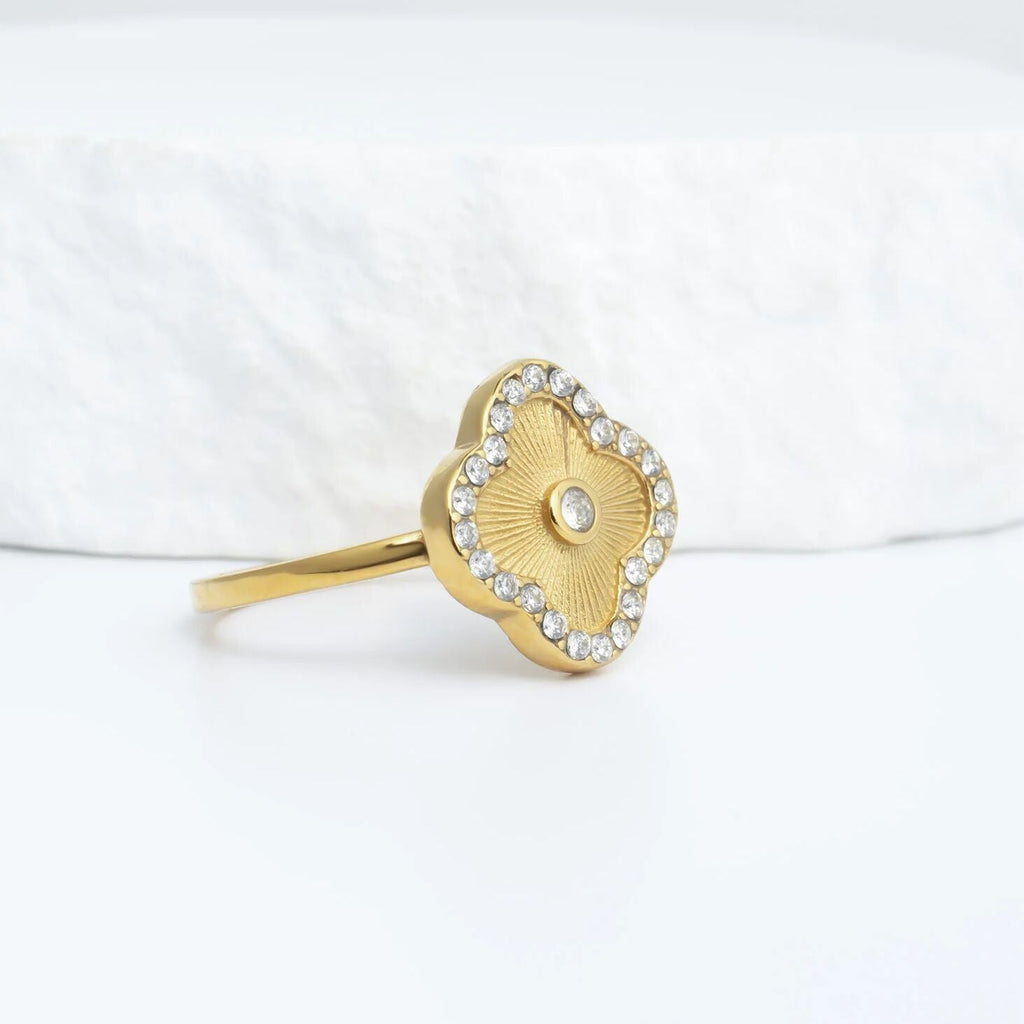 Gold Floral Motif Ring with a floral design on a white background