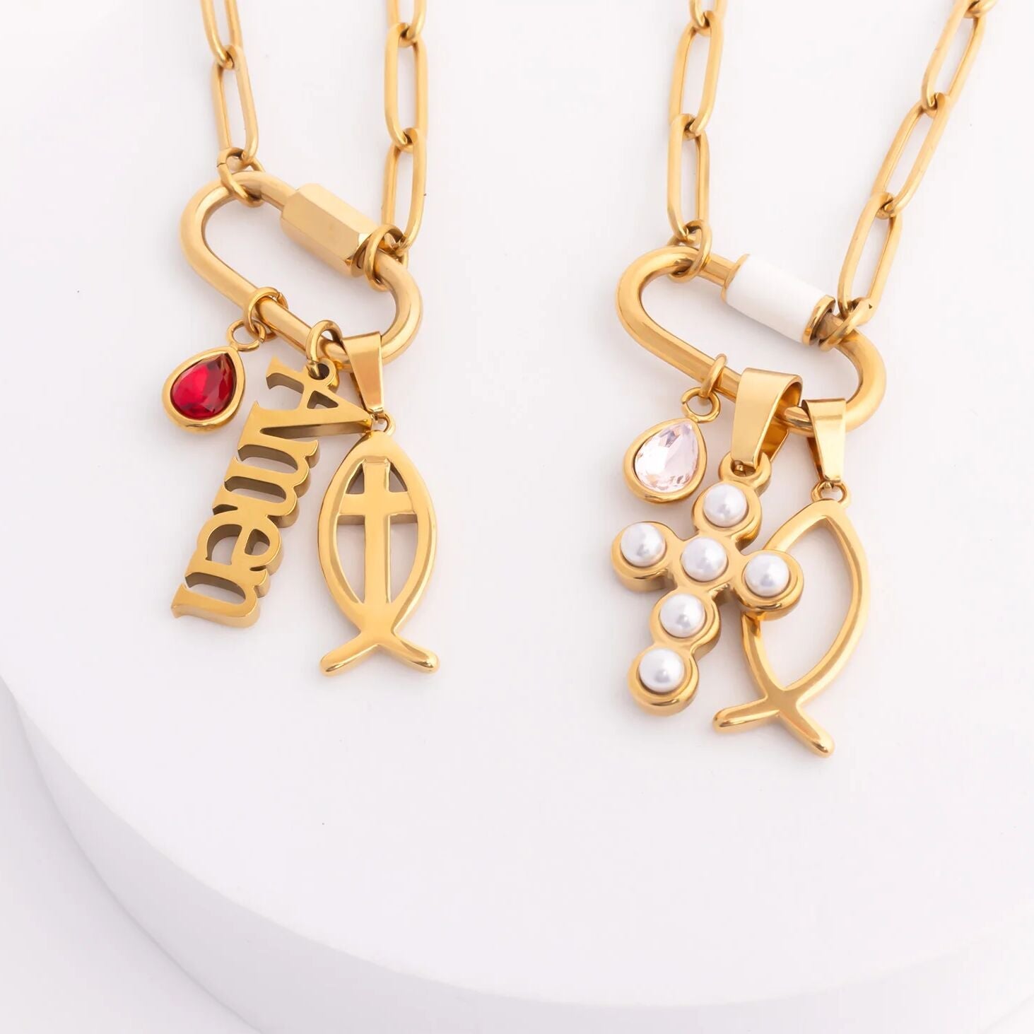 Two gold necklaces with pendants on a white background