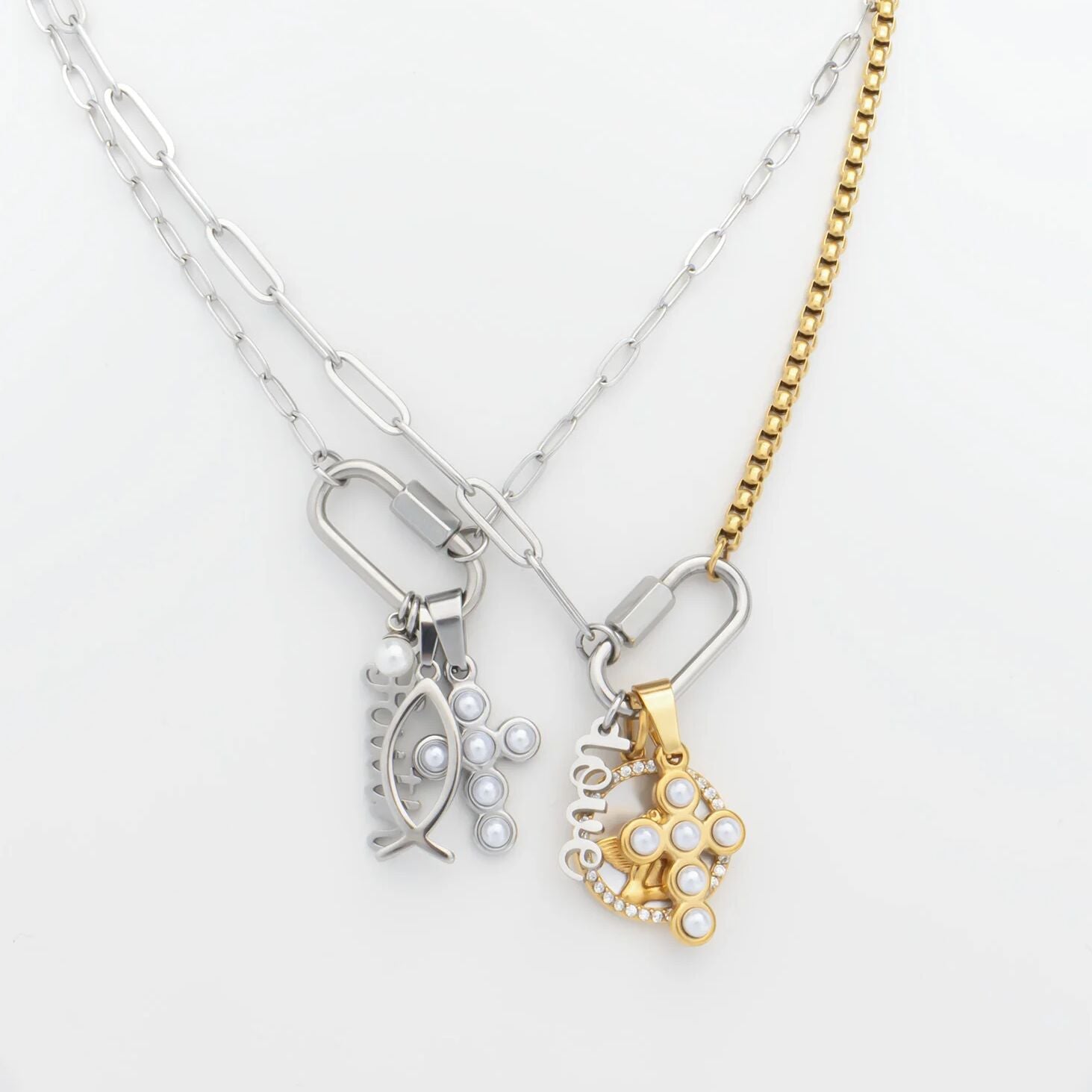 Two necklaces with fish-shaped pendants on a white background