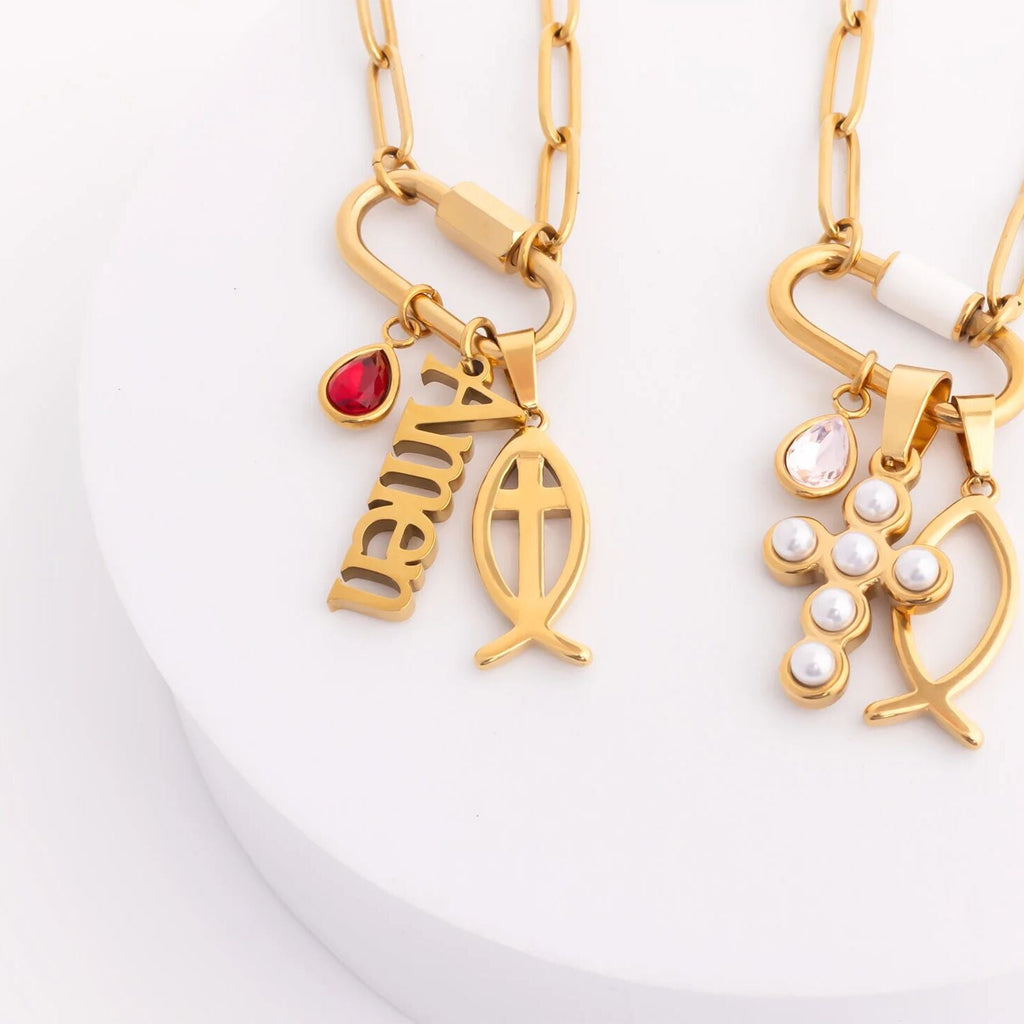 Two gold necklaces with religious symbols on a white background