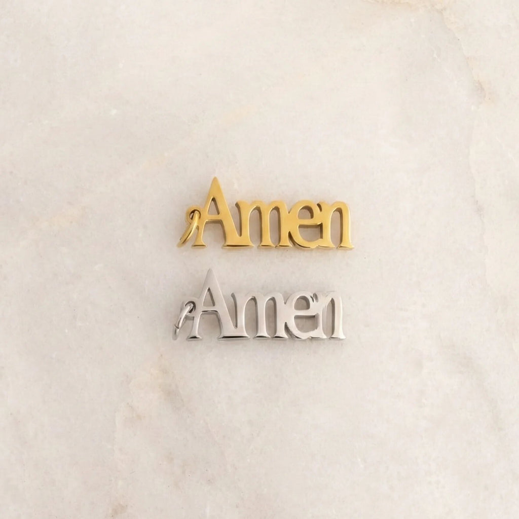 Gold and silver 'Amen' decorations on a marble surface