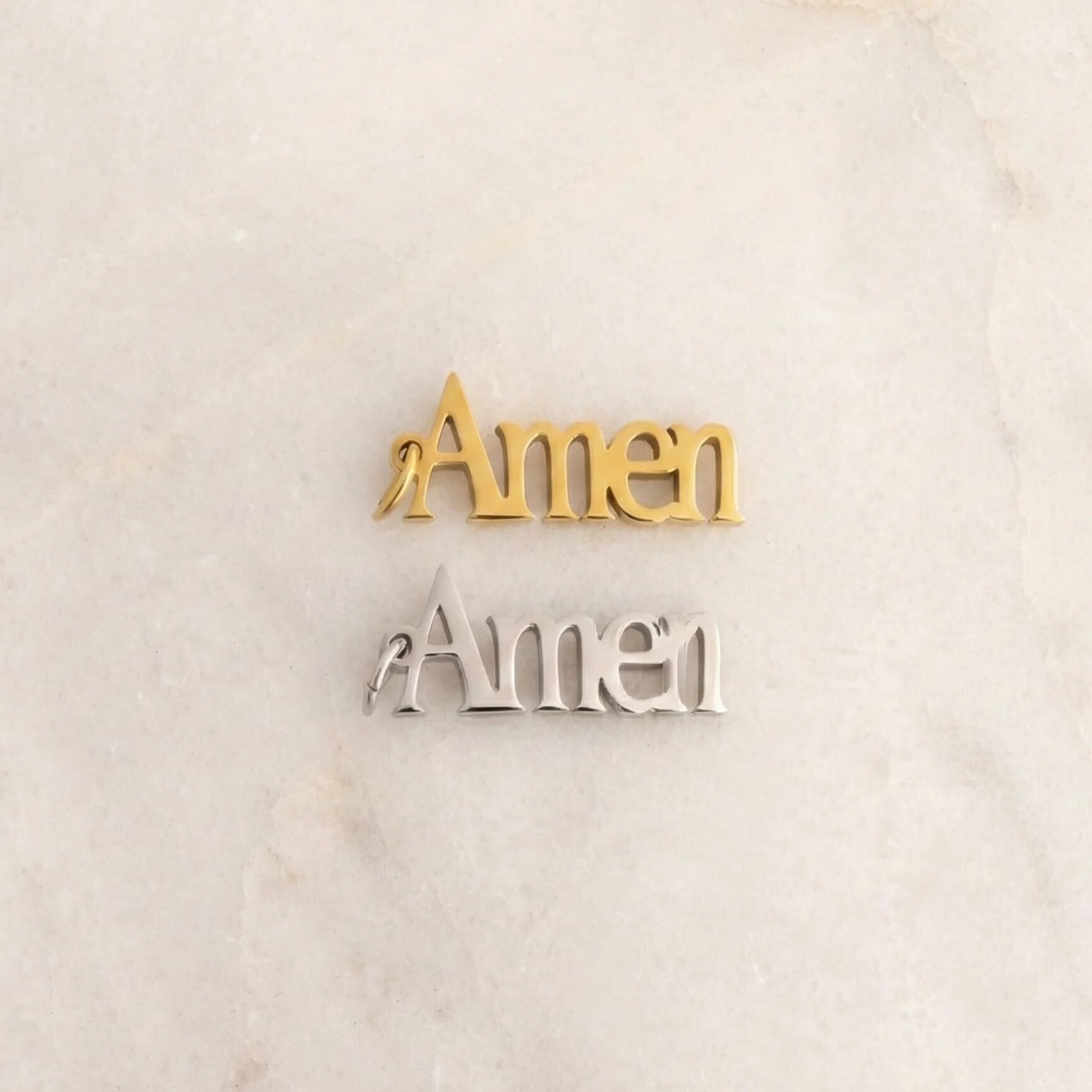 Gold and silver 'Amen' decorations on a marble surface