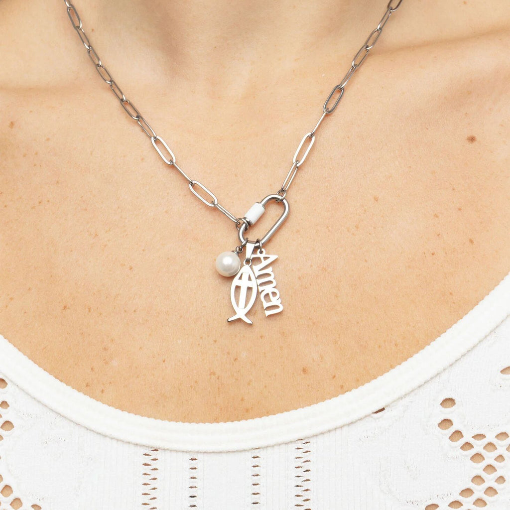 Silver necklace with a pendant and pearl on a person's neck