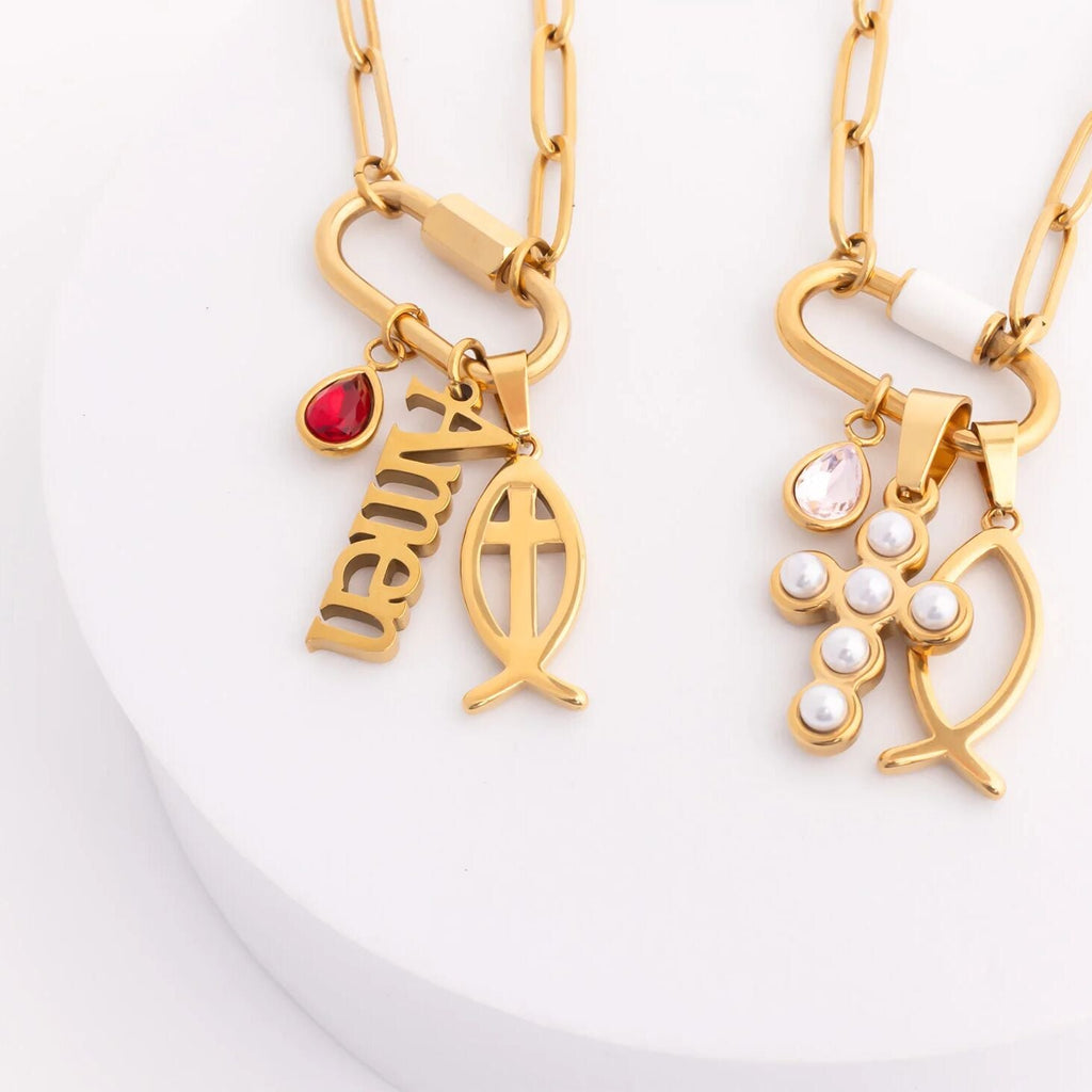 Two gold necklaces with fish pendants on a white background